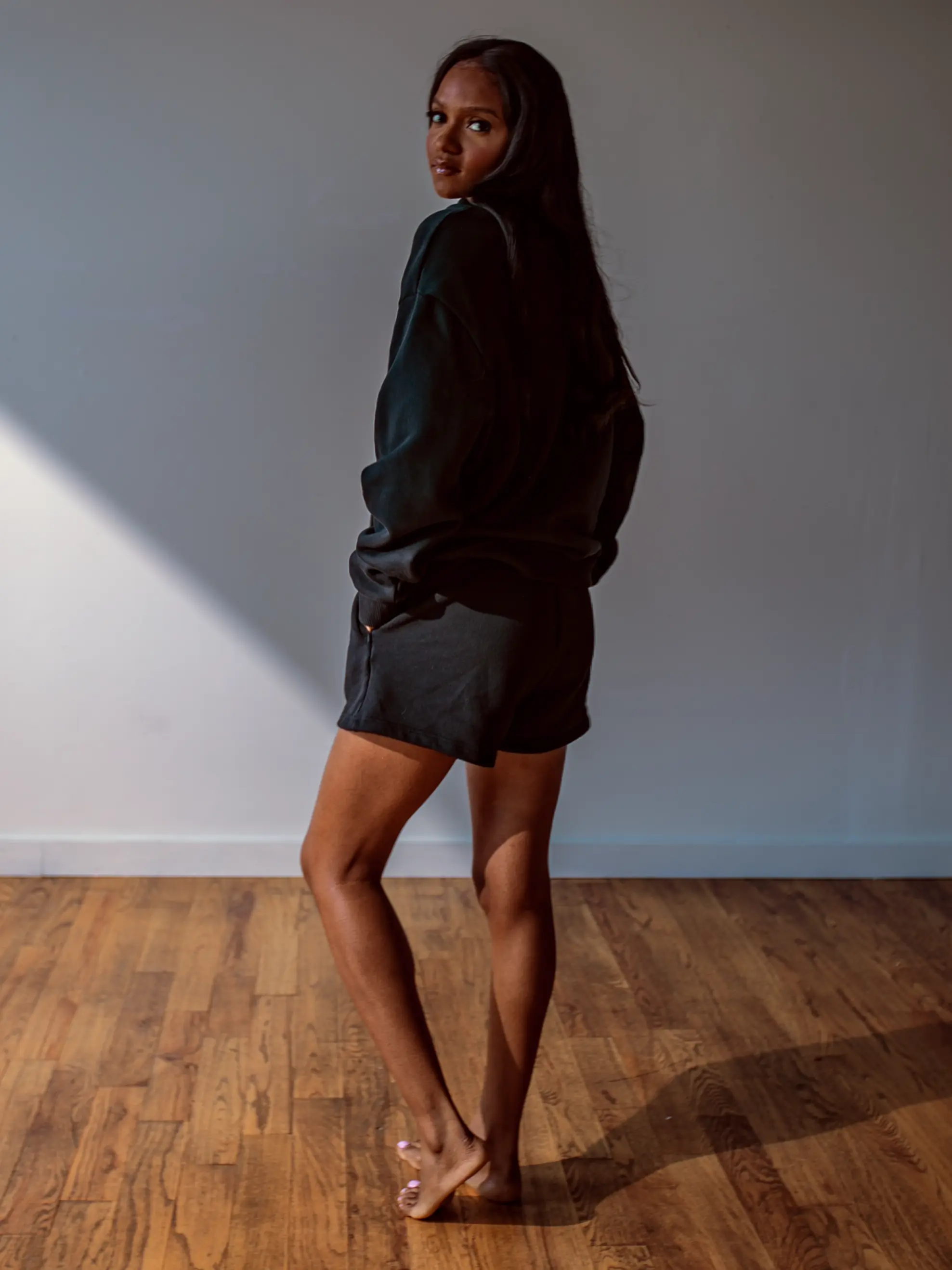 Close-up of a single green leaf against a white background.