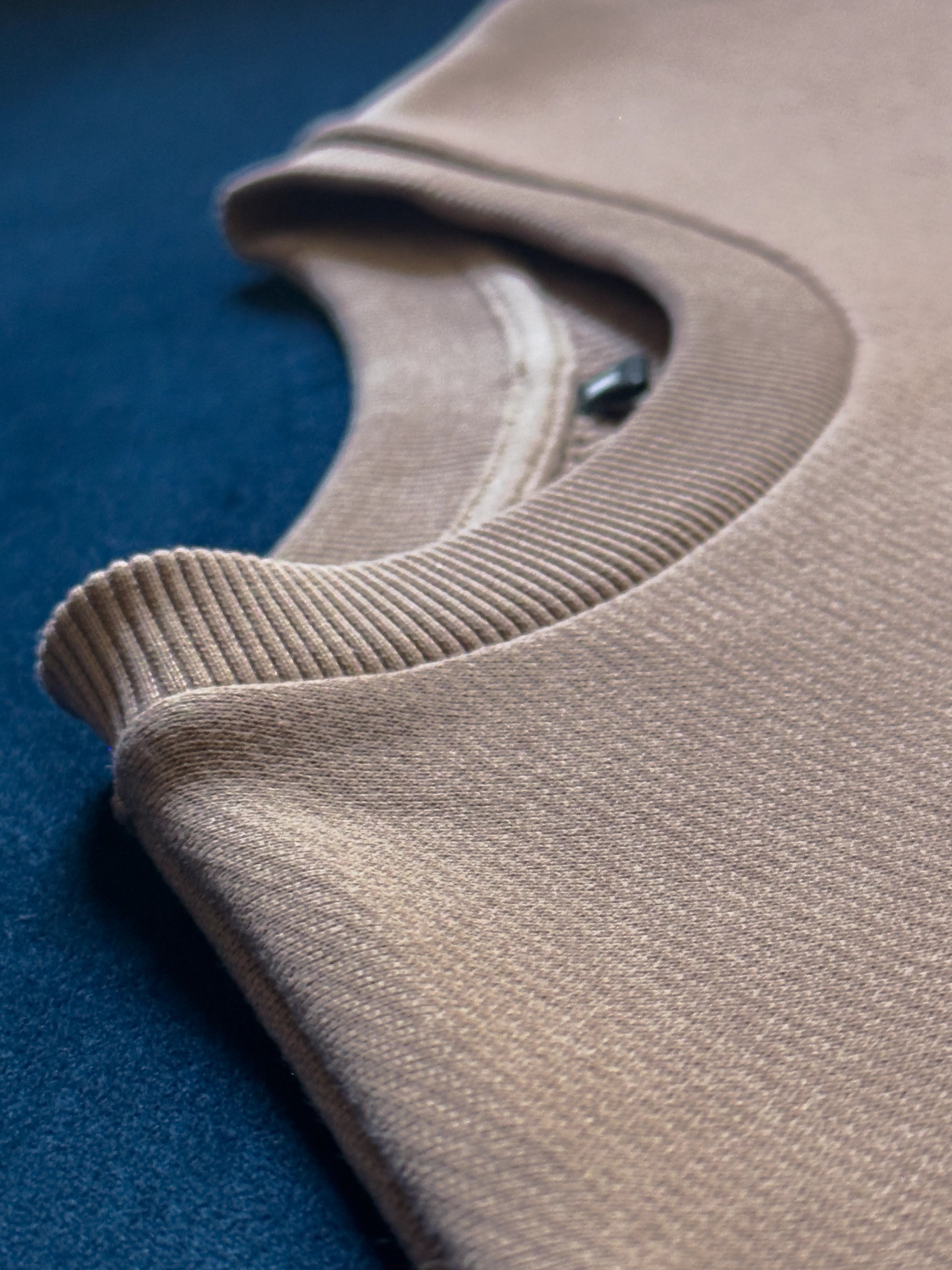 Close-up of a single green leaf against a white background.