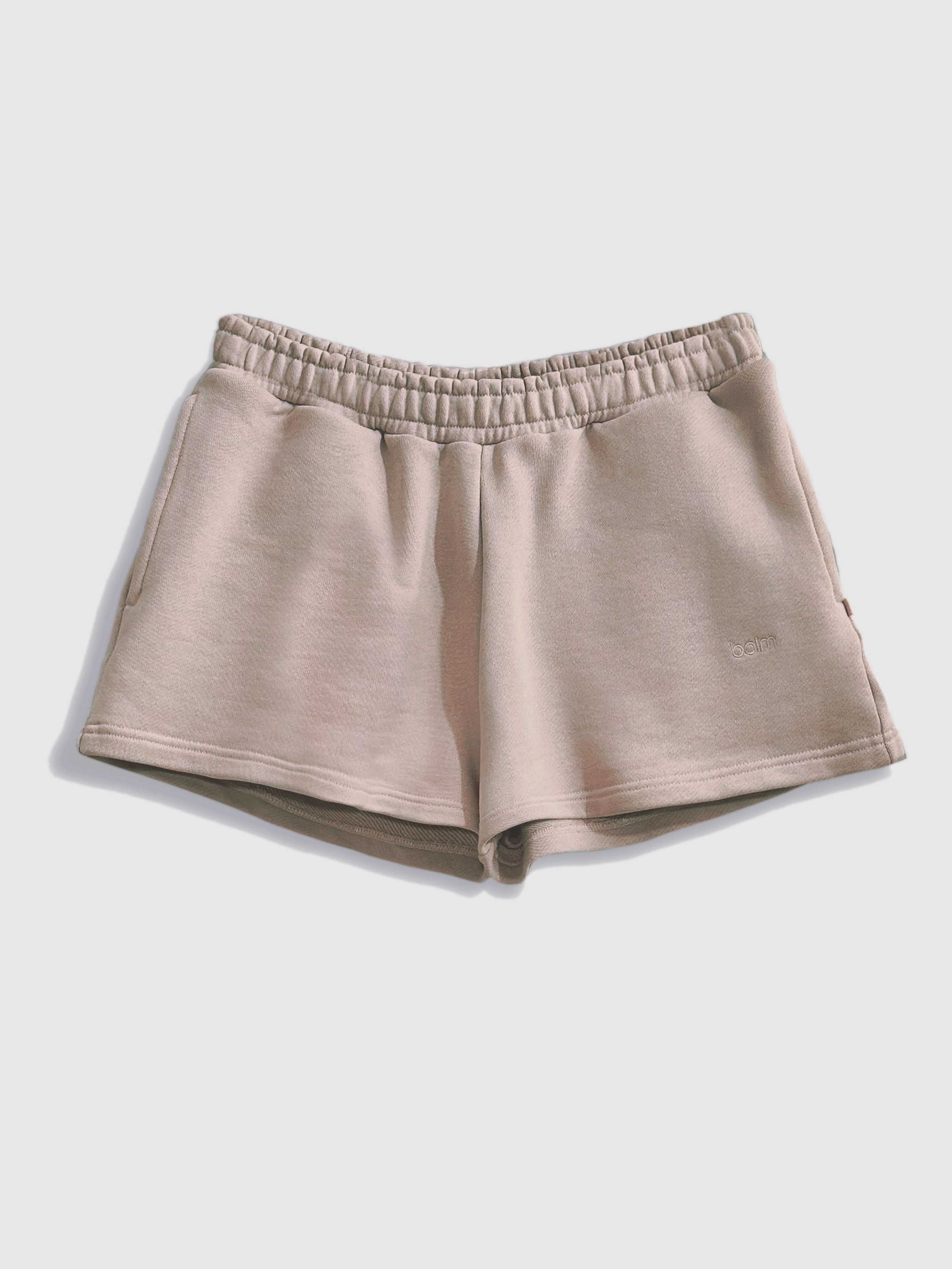 Close-up of a single green leaf against a white background.