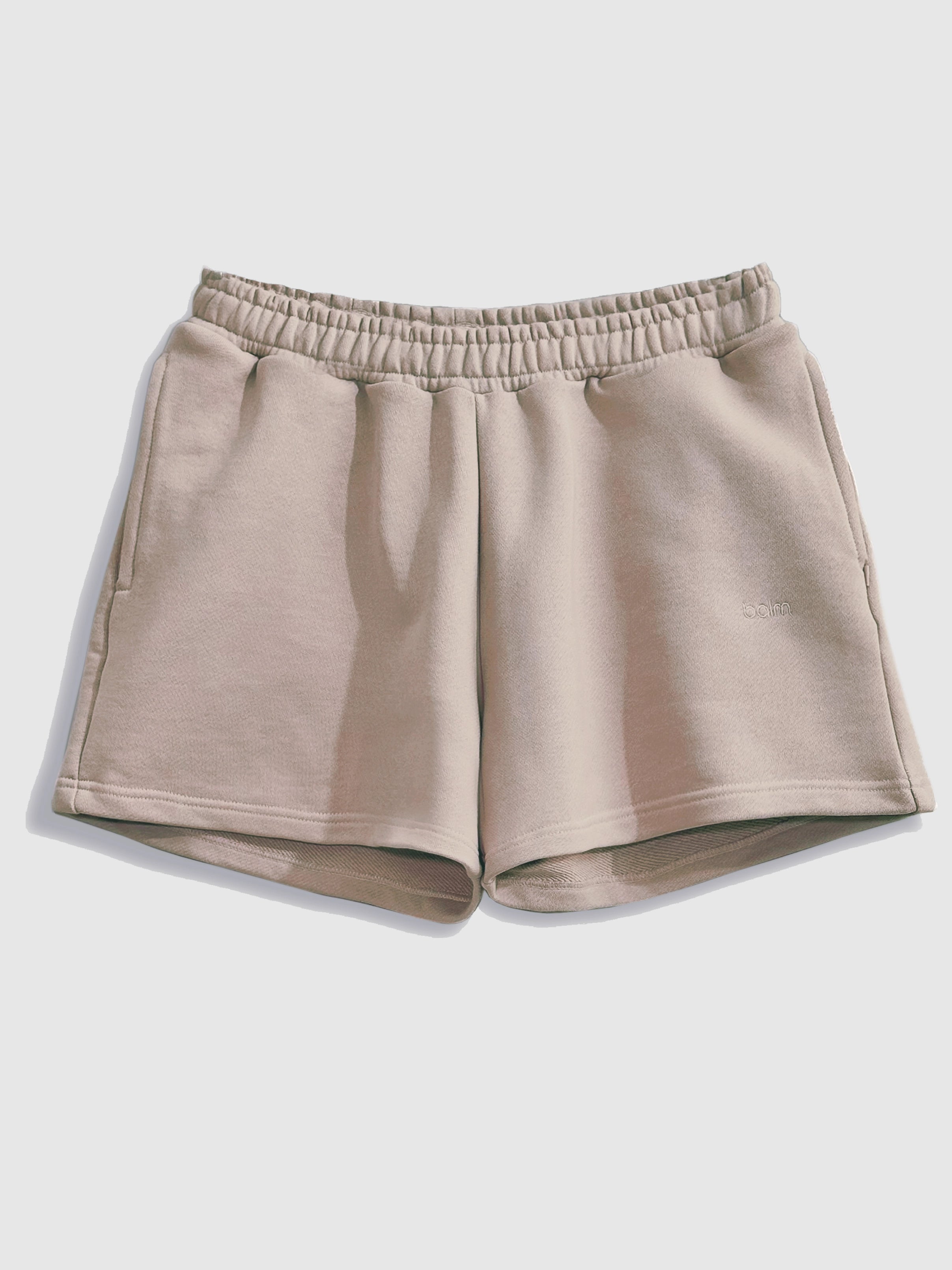 Close-up of a single green leaf against a white background.