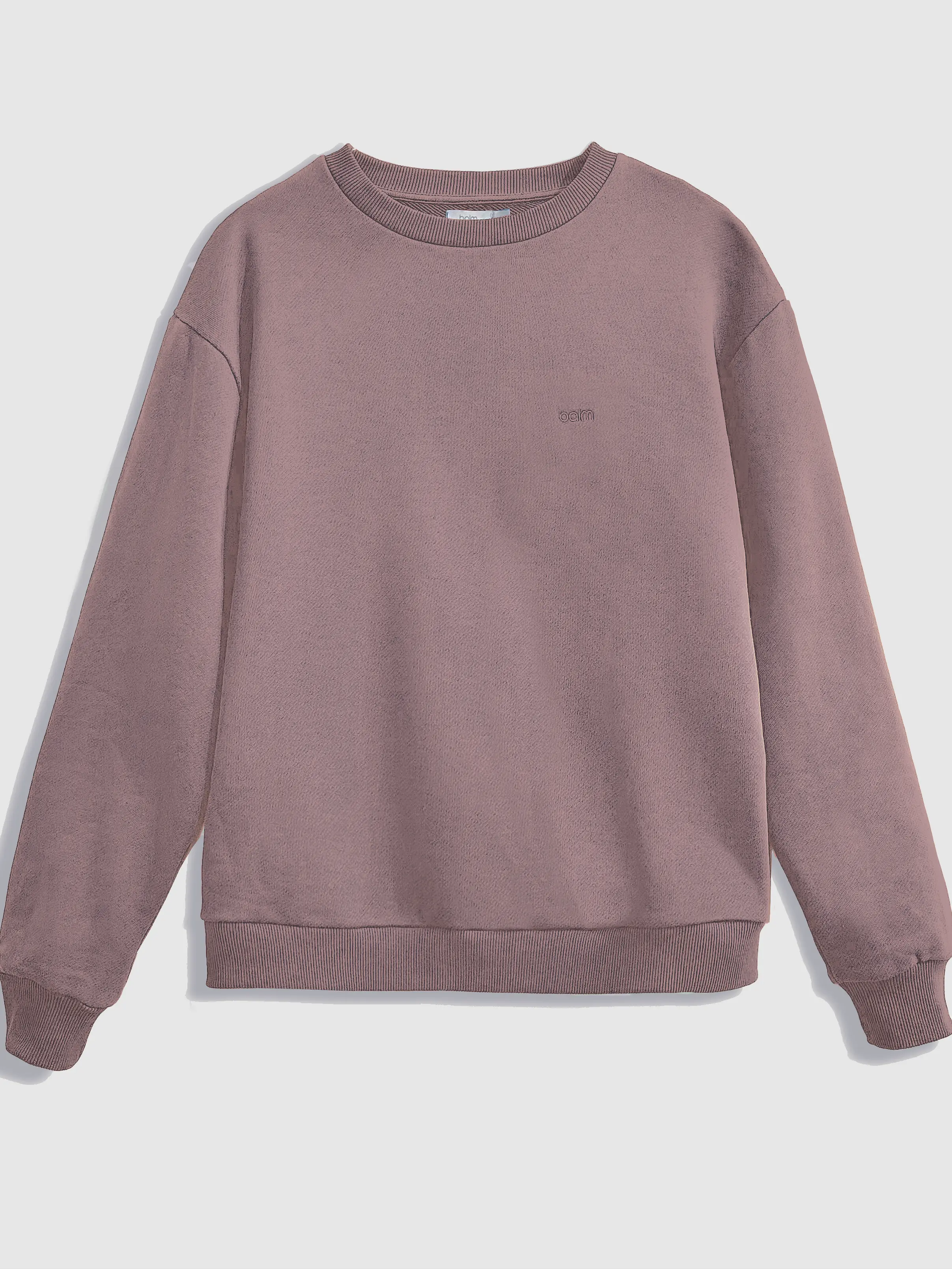 Close-up of a single green leaf against a white background.