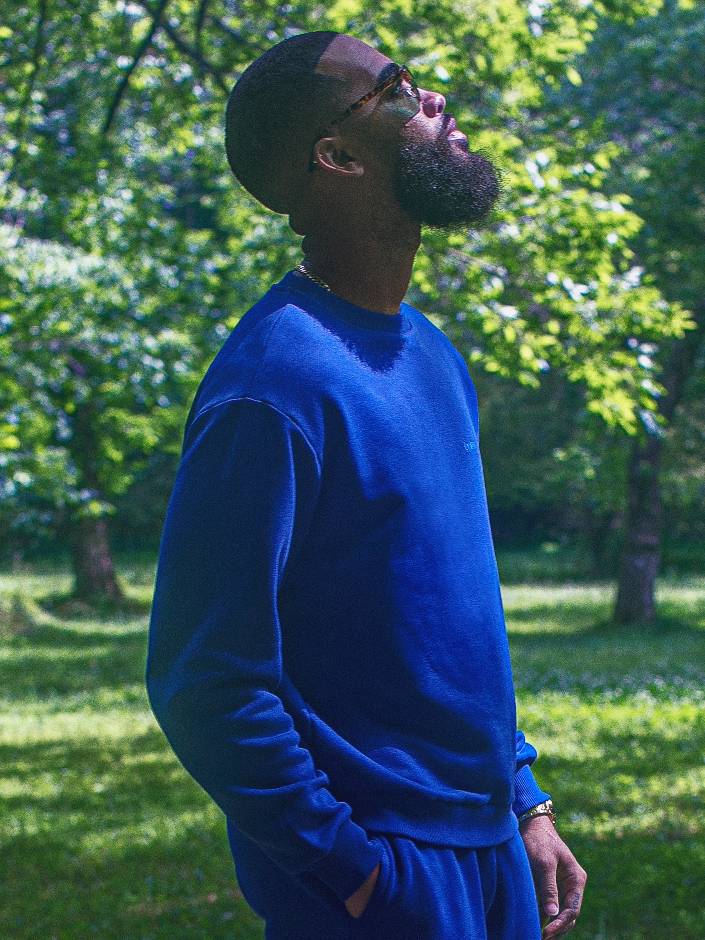 Cream-colored hoodie on a wood-textured background.