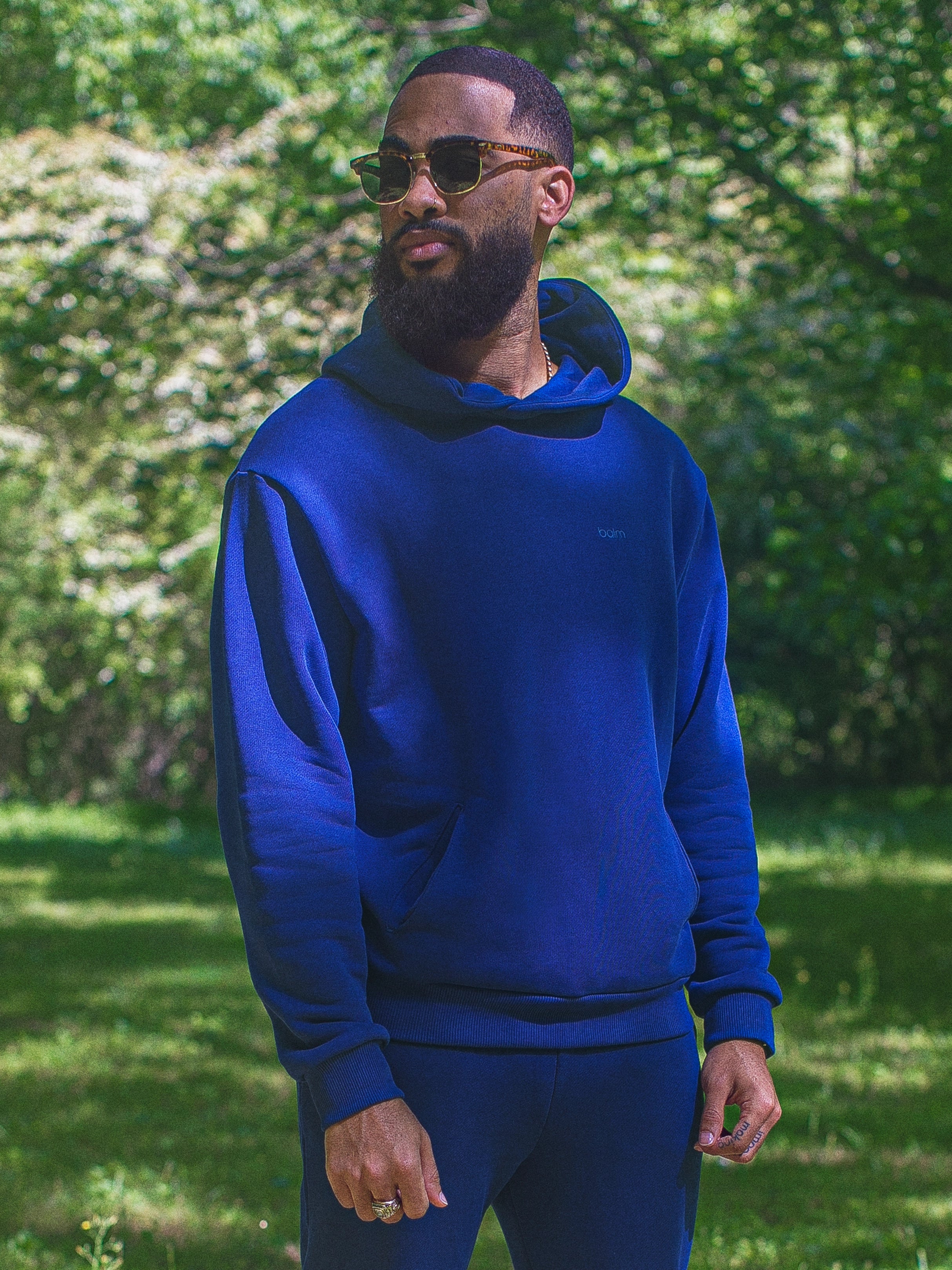 Cream-colored hoodie on a wood-textured background.