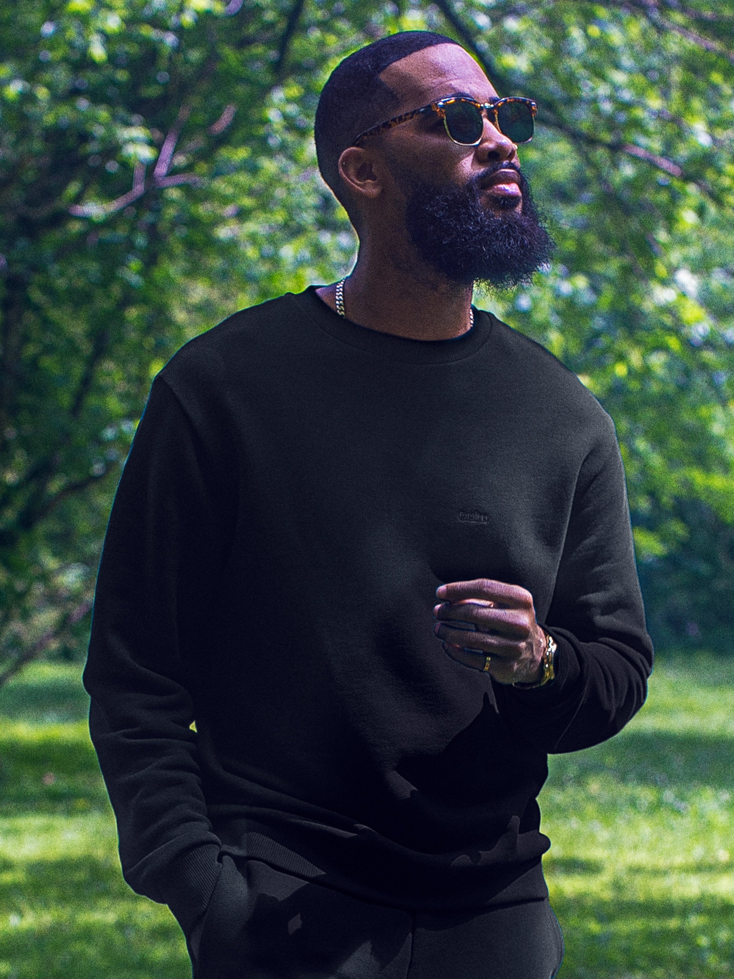 Cream-colored hoodie on a wood-textured background.