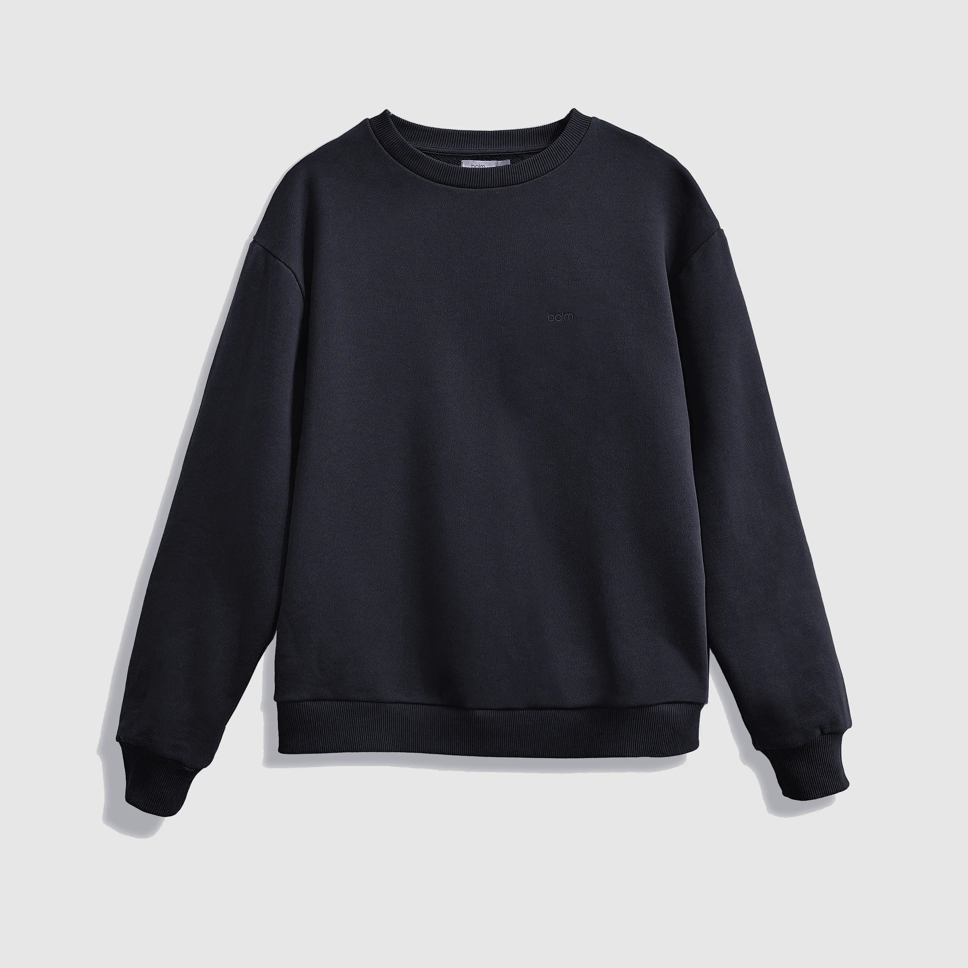 Cream-colored hoodie on a wood-textured background.