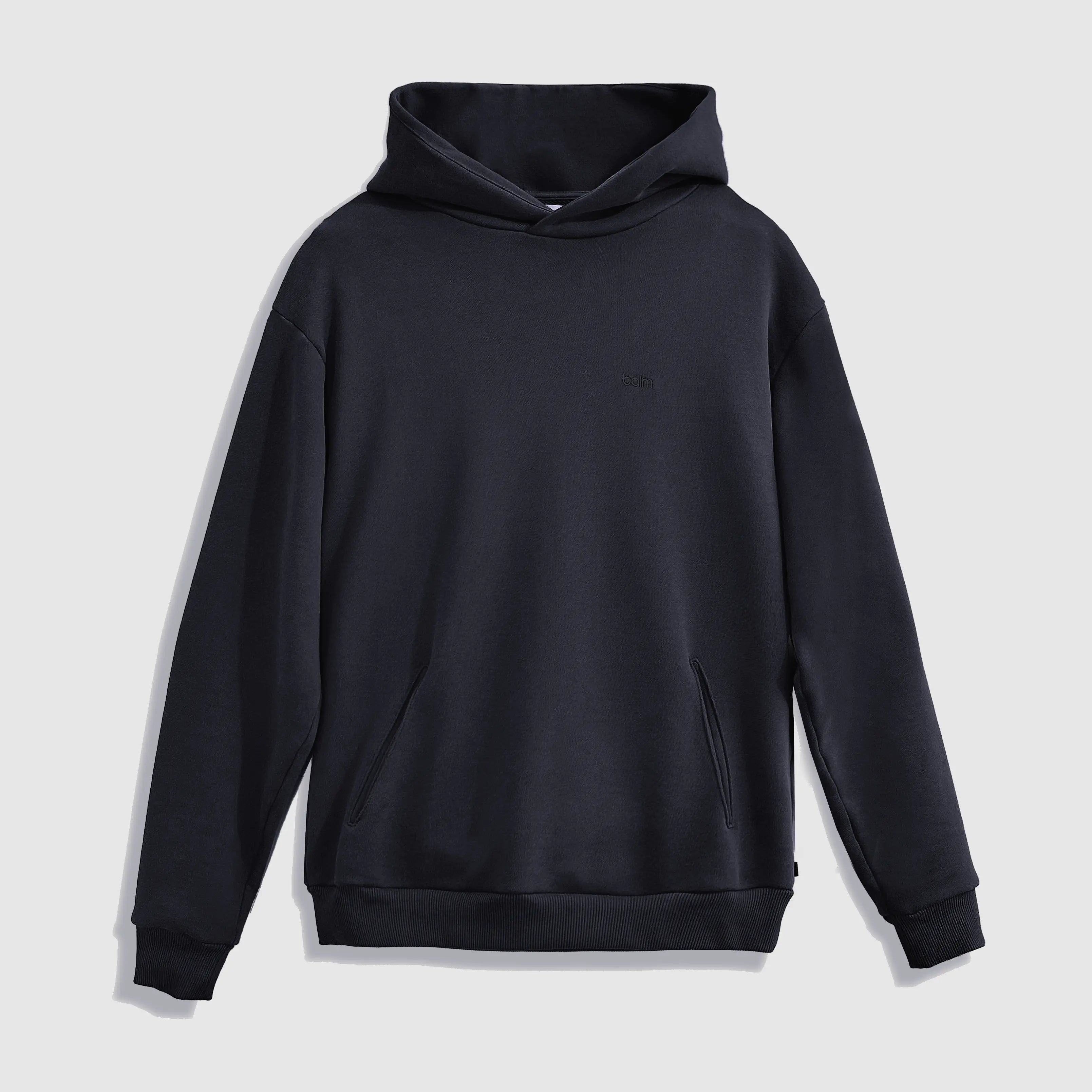 Cream-colored hoodie on a wood-textured background.