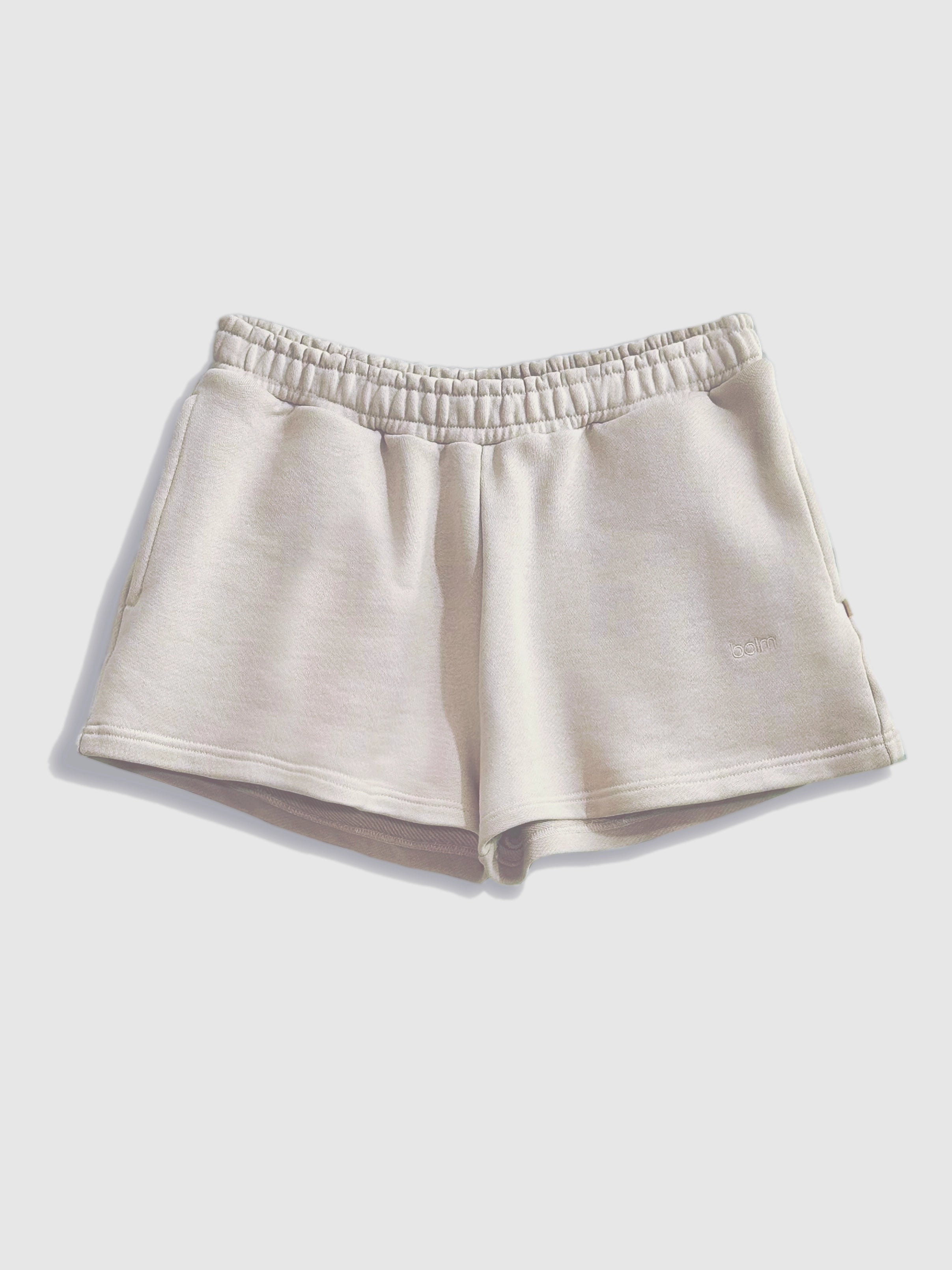 Close-up of a single green leaf against a white background.