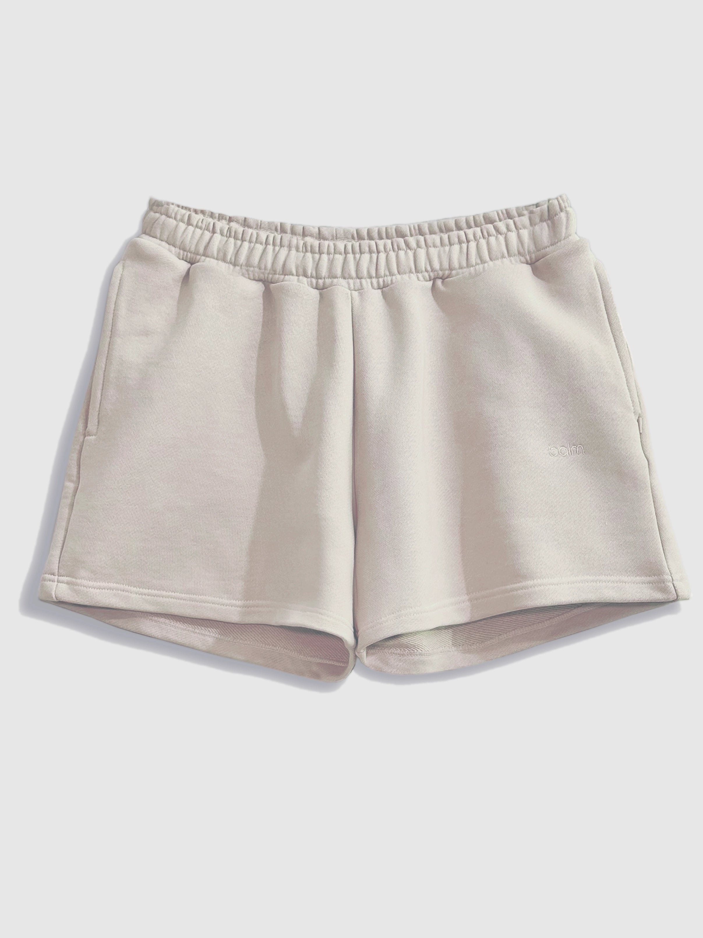 Close-up of a single green leaf against a white background.