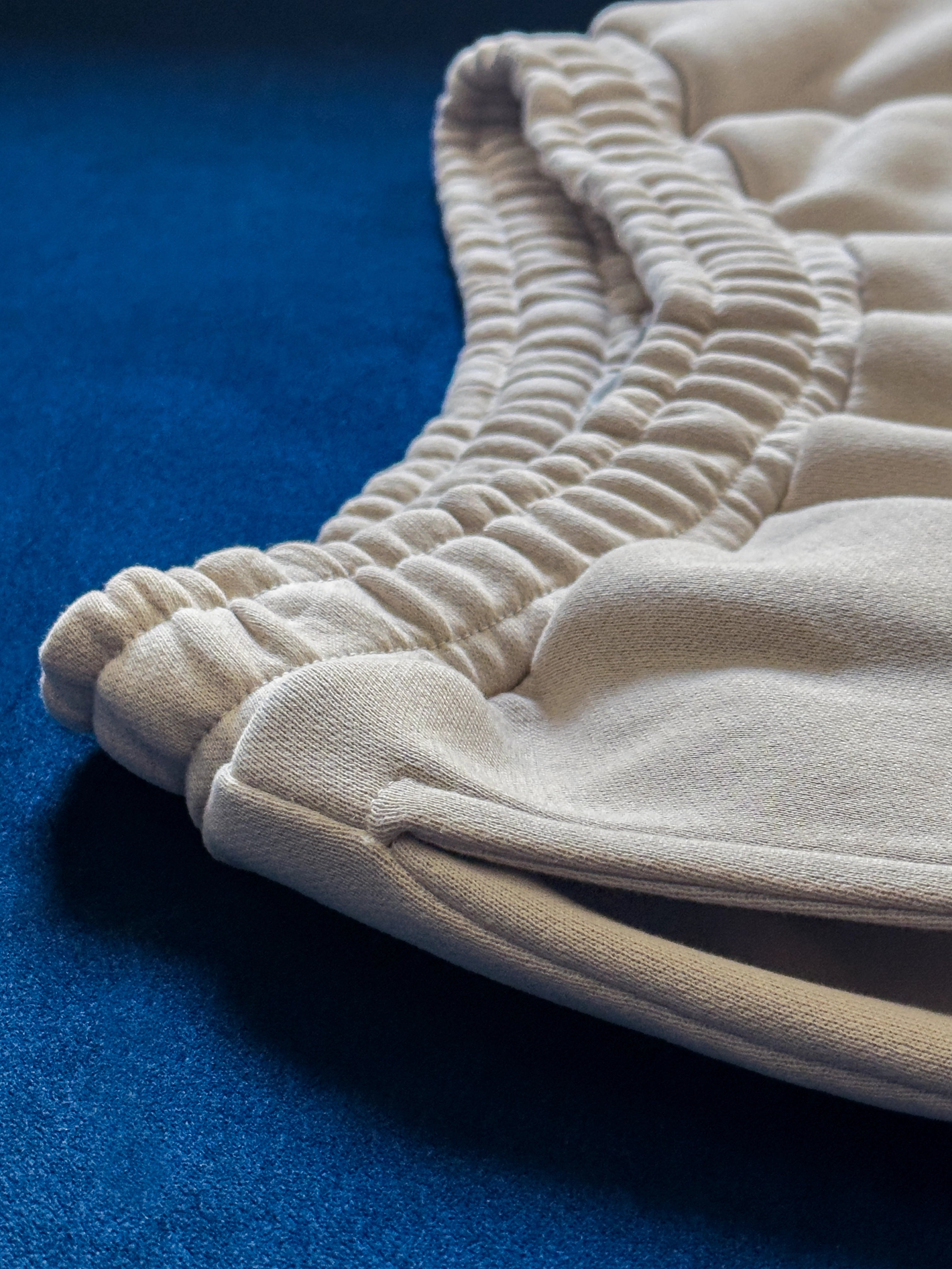 Close-up of a single green leaf against a white background.