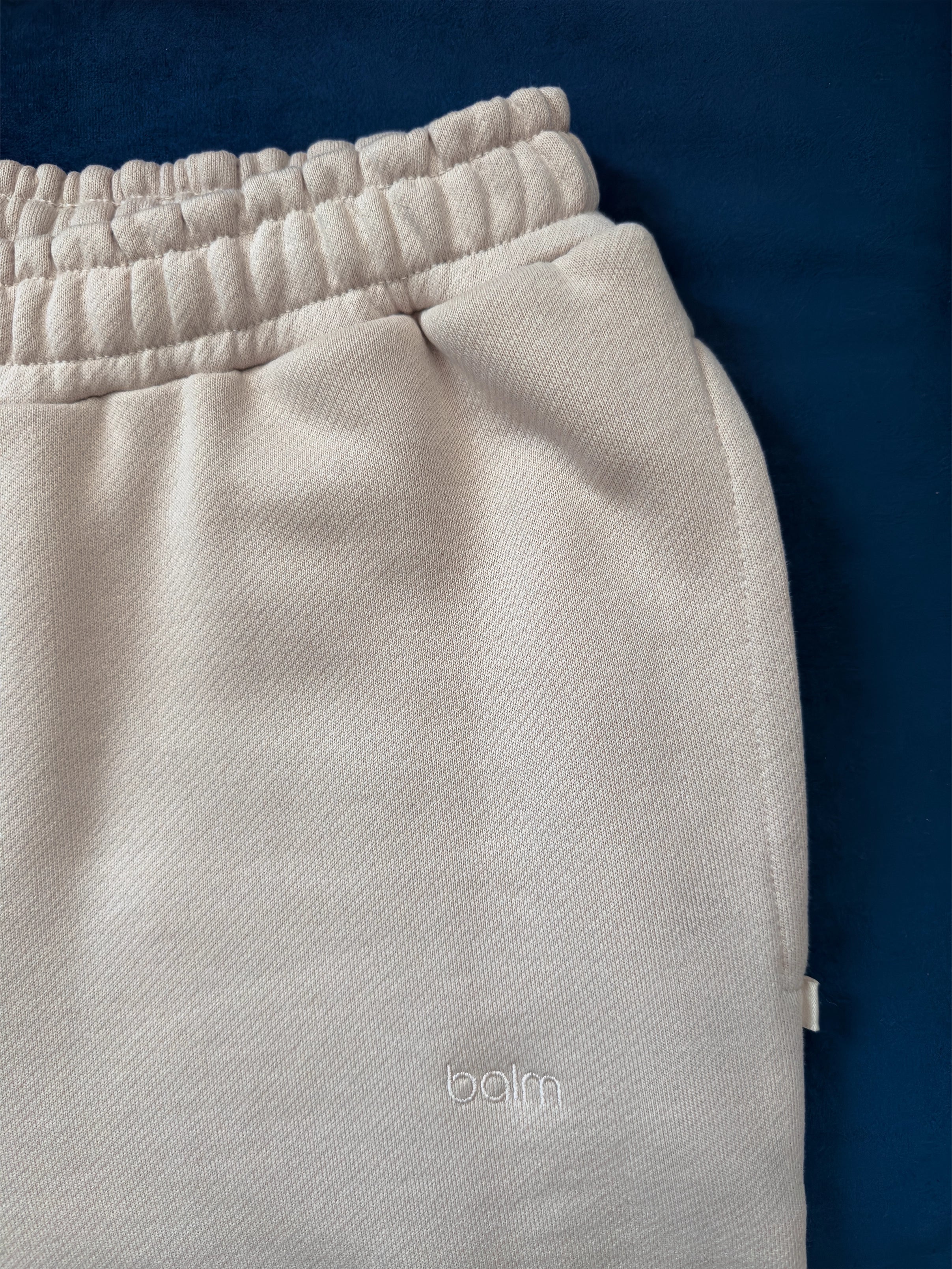 Close-up of a single green leaf against a white background.
