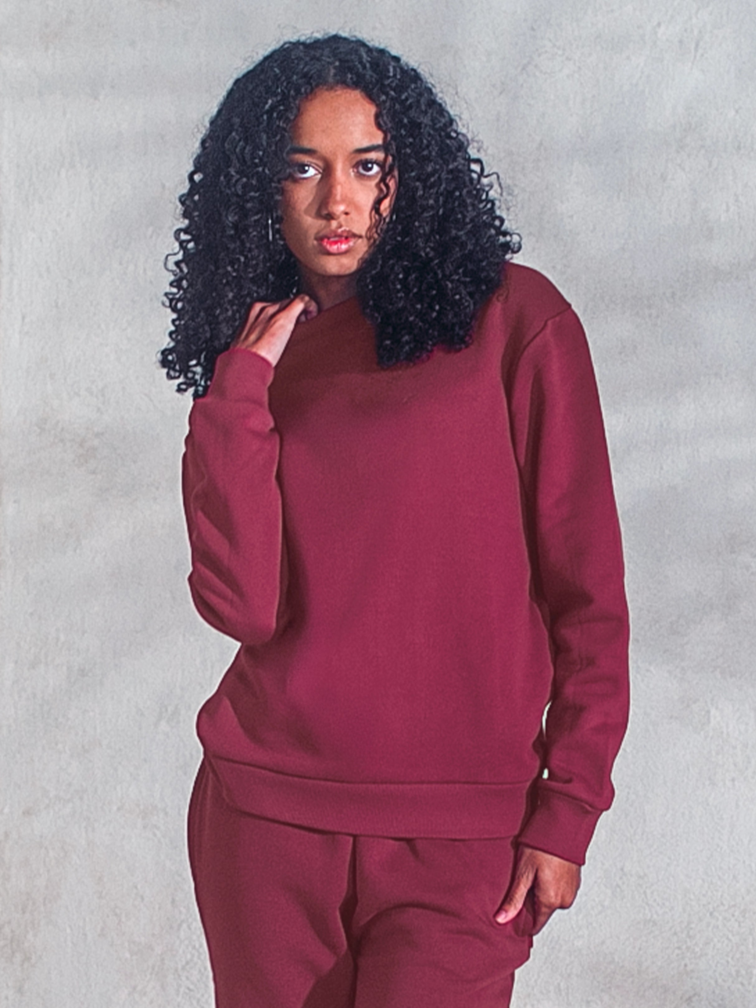 Cream-colored hoodie on a wood-textured background.