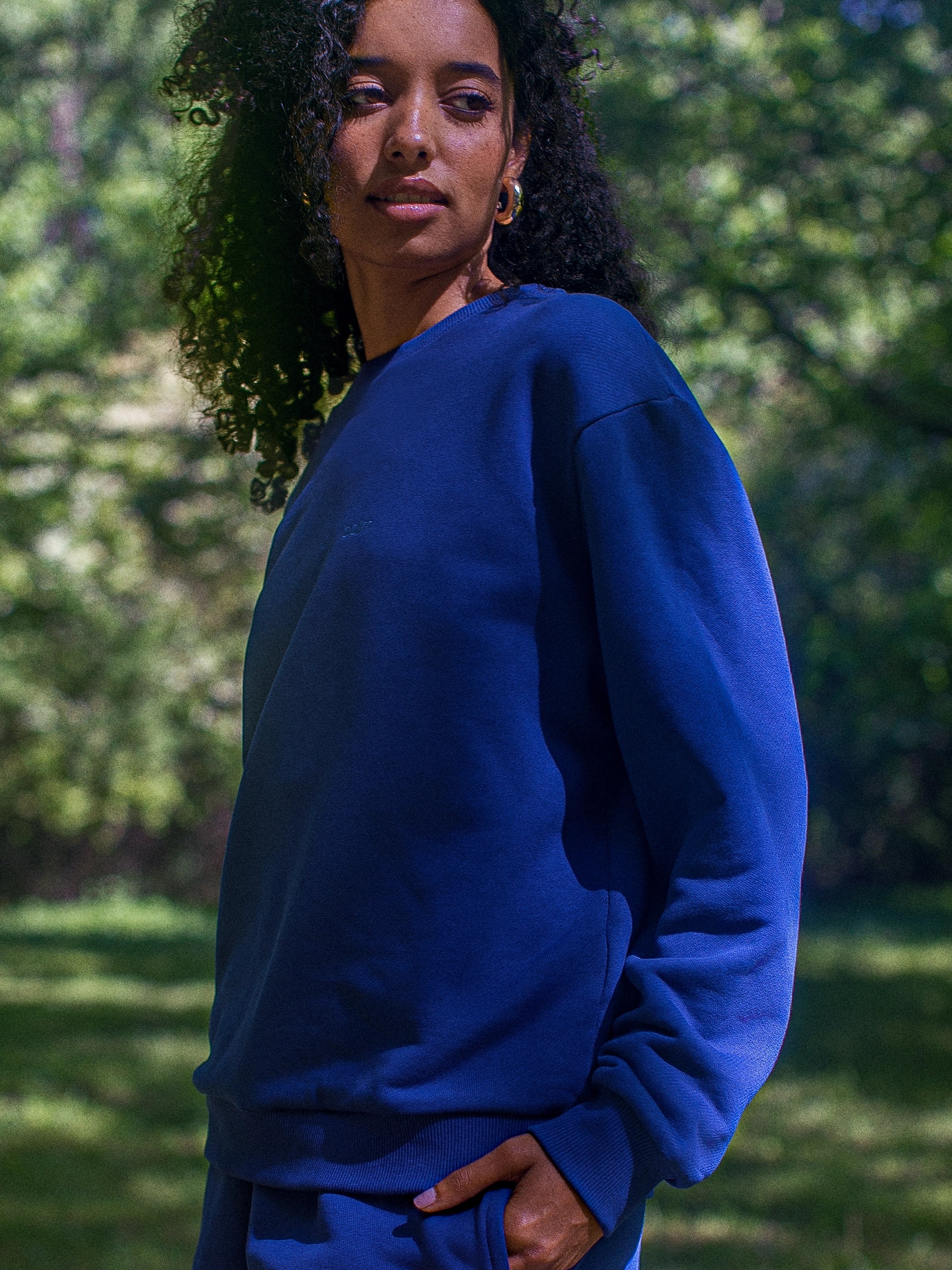 Cream-colored hoodie on a wood-textured background.