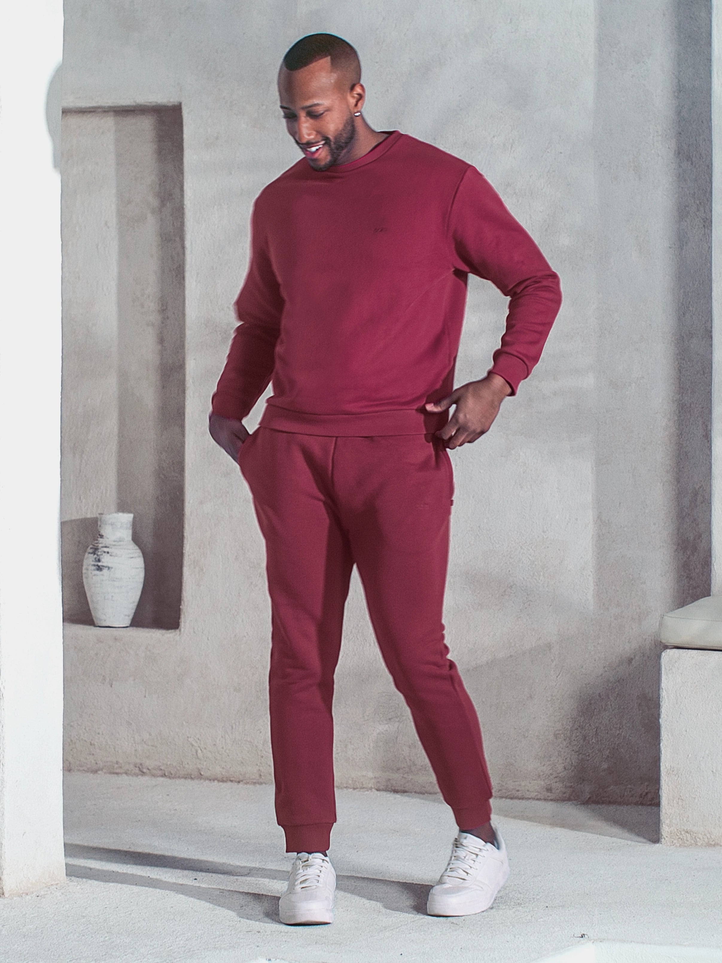 Cream-colored hoodie on a wood-textured background.