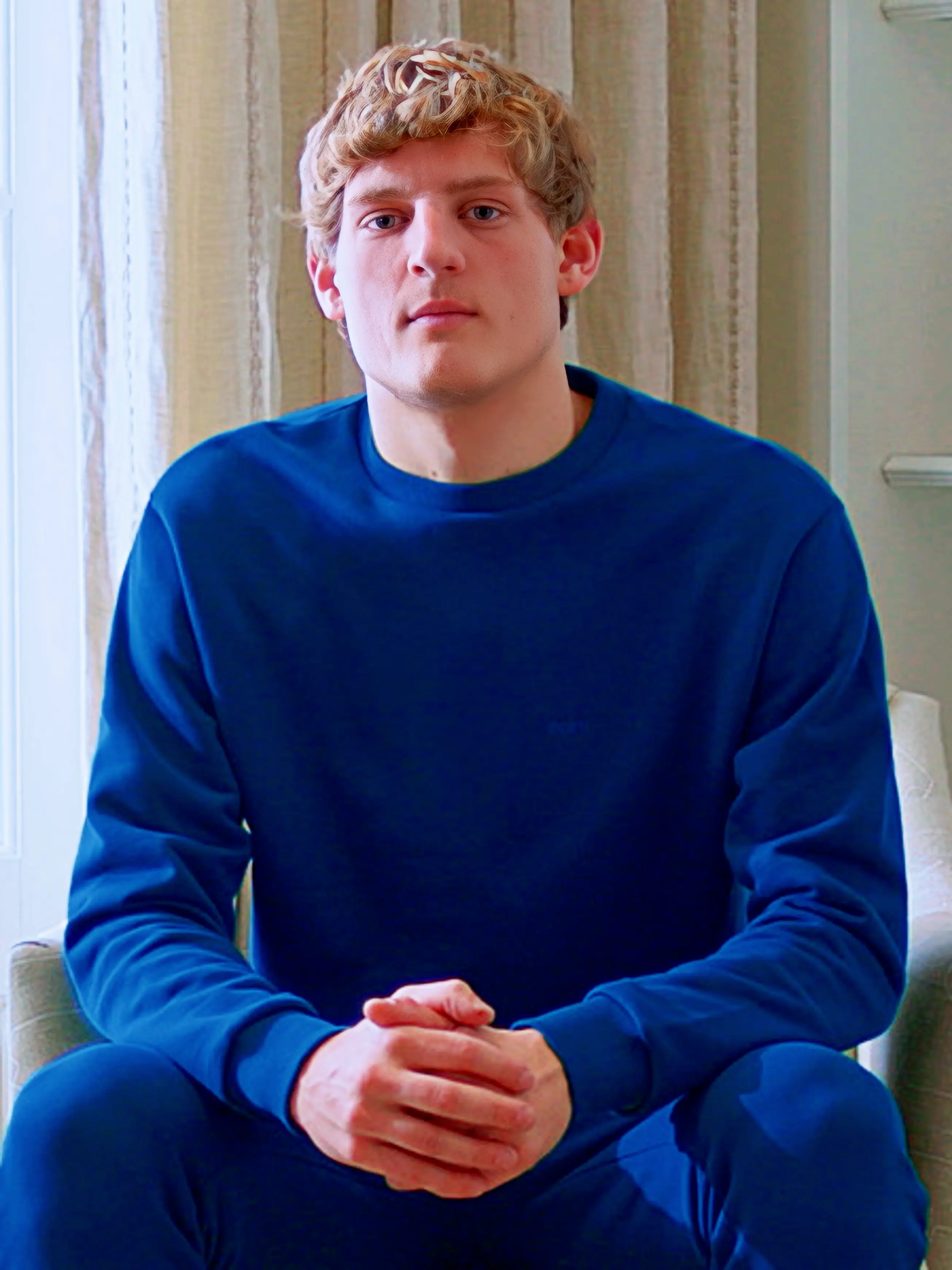 Cream-colored hoodie on a wood-textured background.