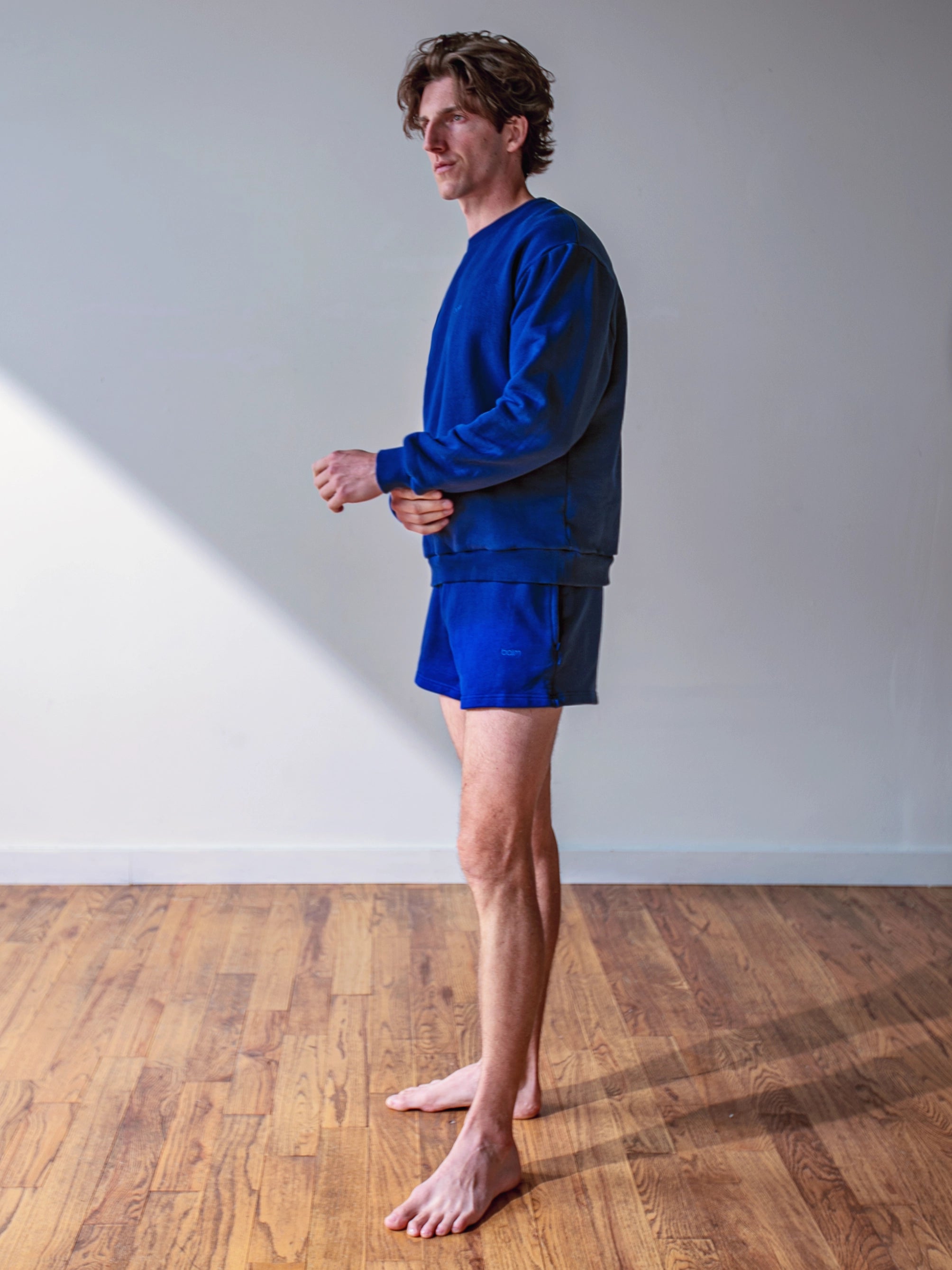 Close-up of a single green leaf against a white background.