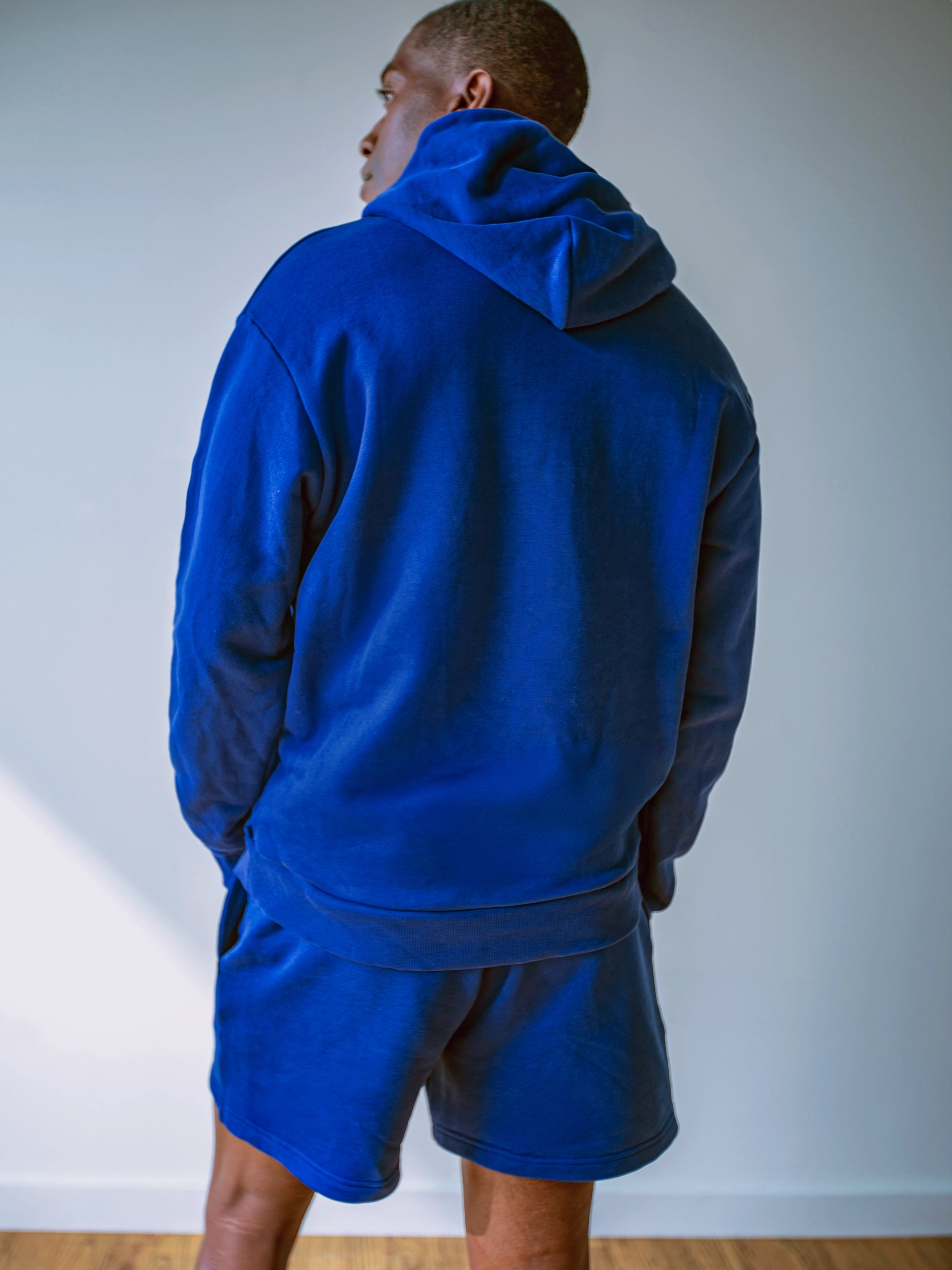 Close-up of a single green leaf against a white background.