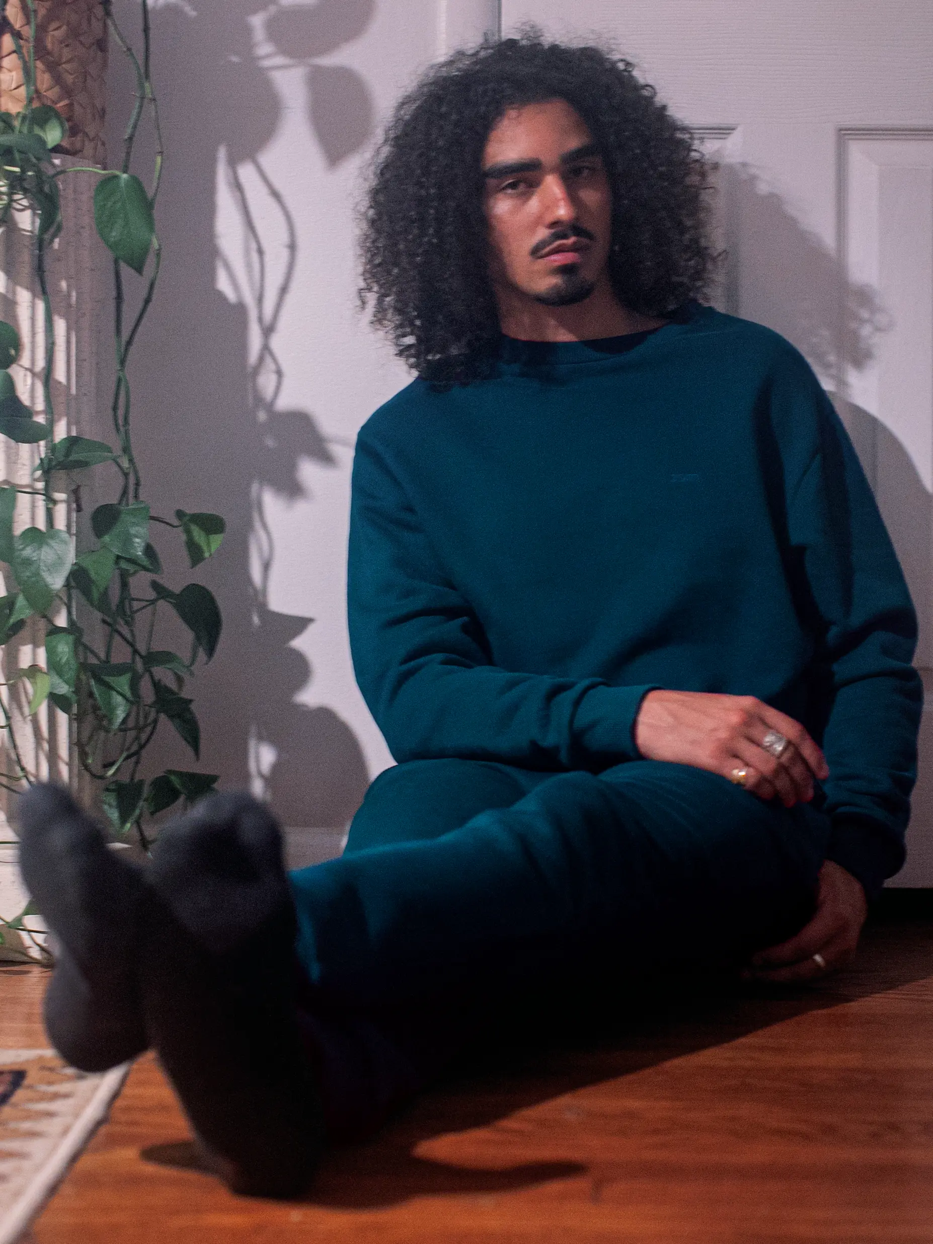 Cream-colored hoodie on a wood-textured background.