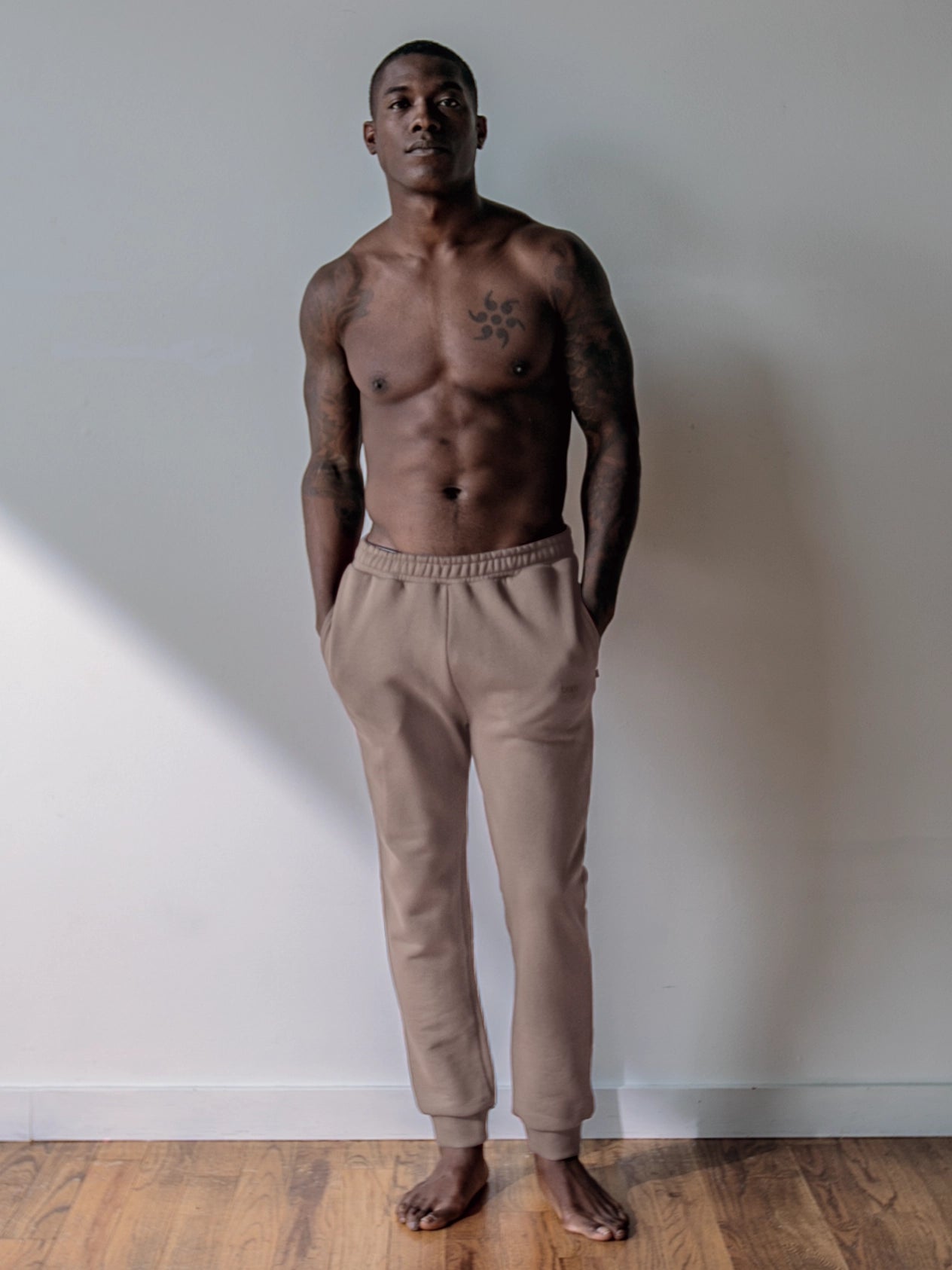 Cream-colored hoodie on a wood-textured background.