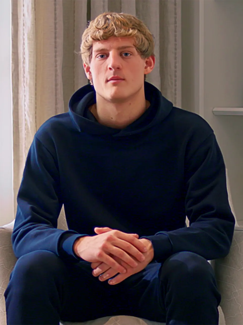 Cream-colored hoodie on a wood-textured background.