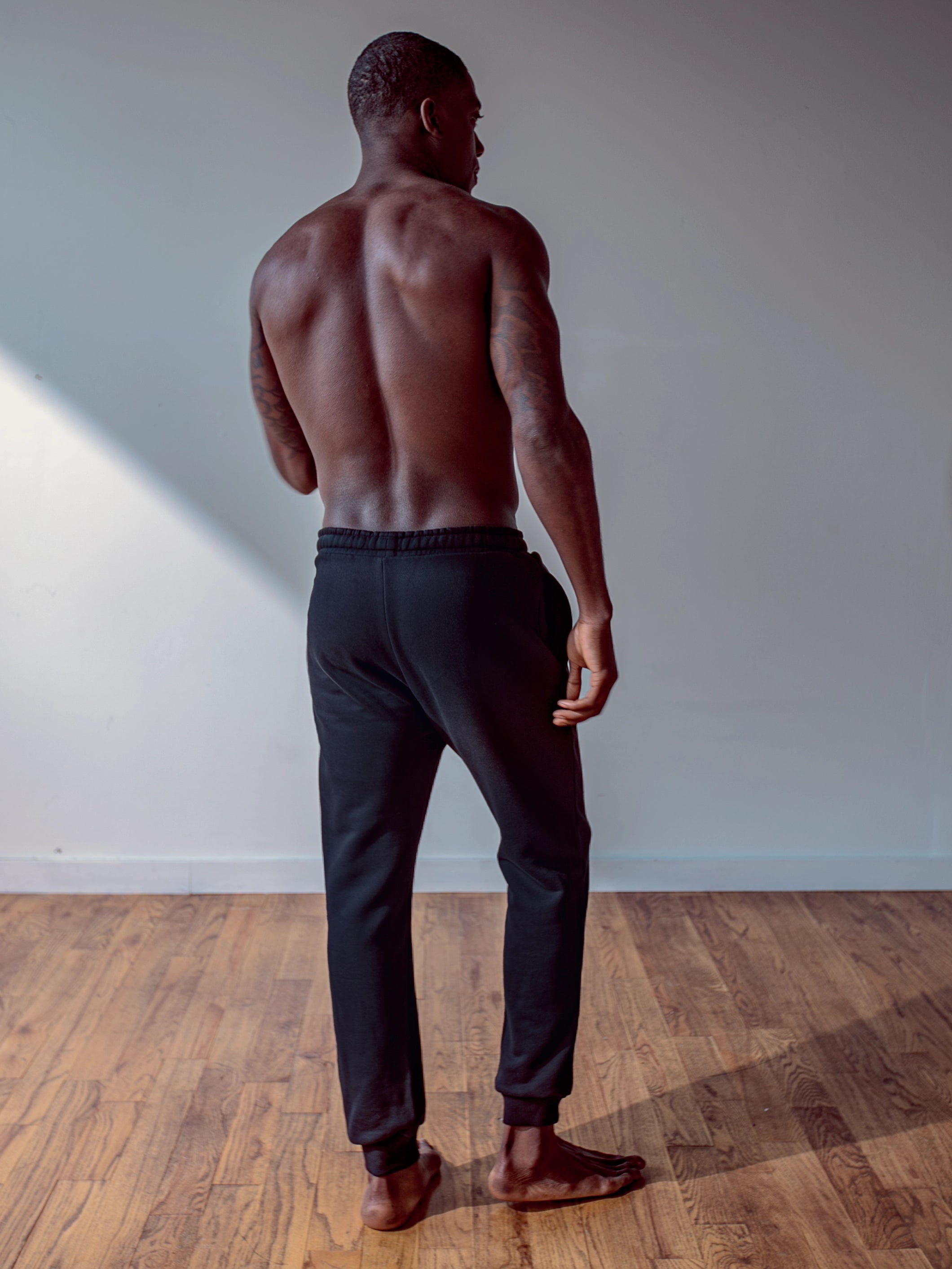 Close-up of a single green leaf against a white background.