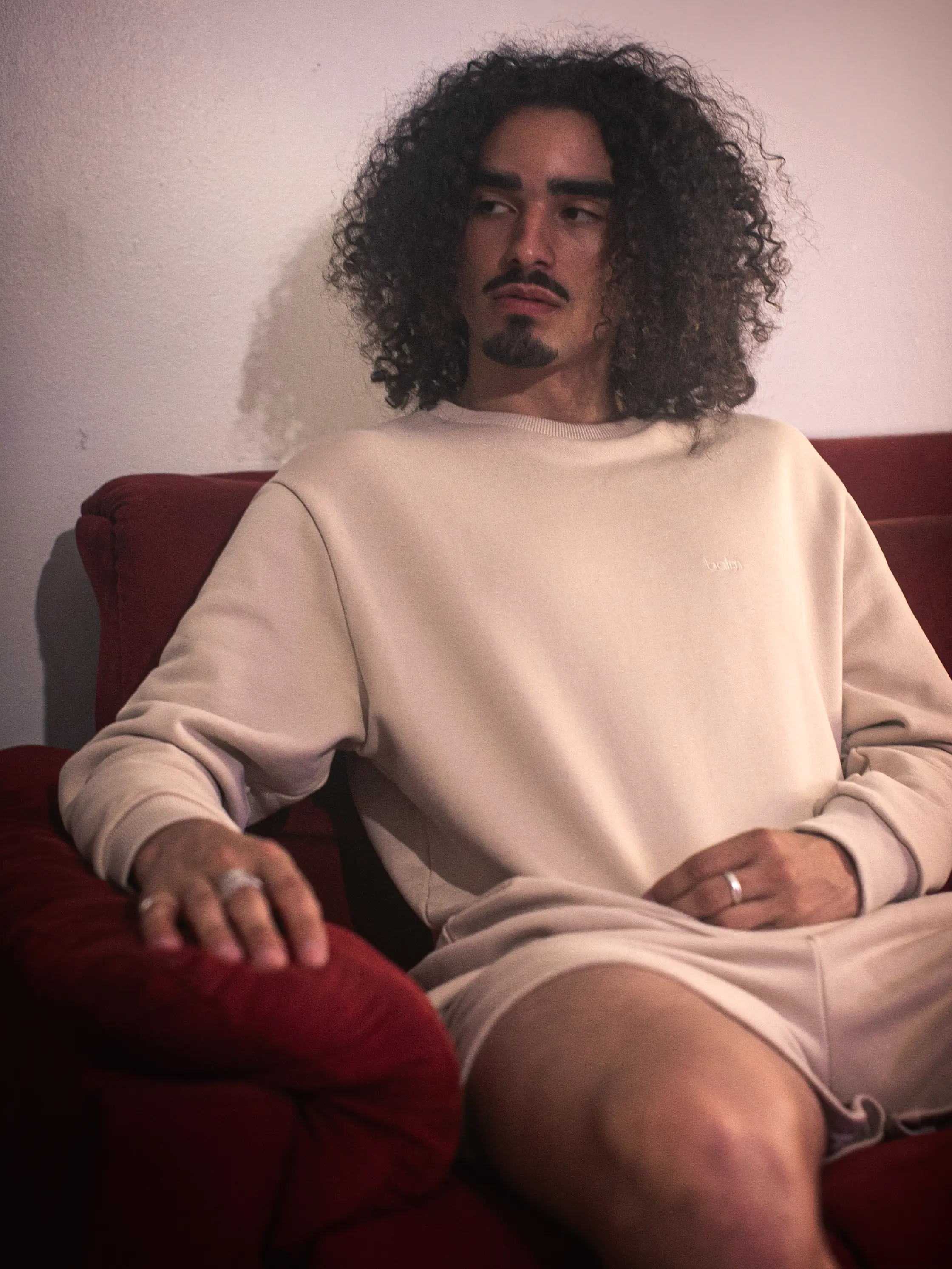 Cream-colored hoodie on a wood-textured background.