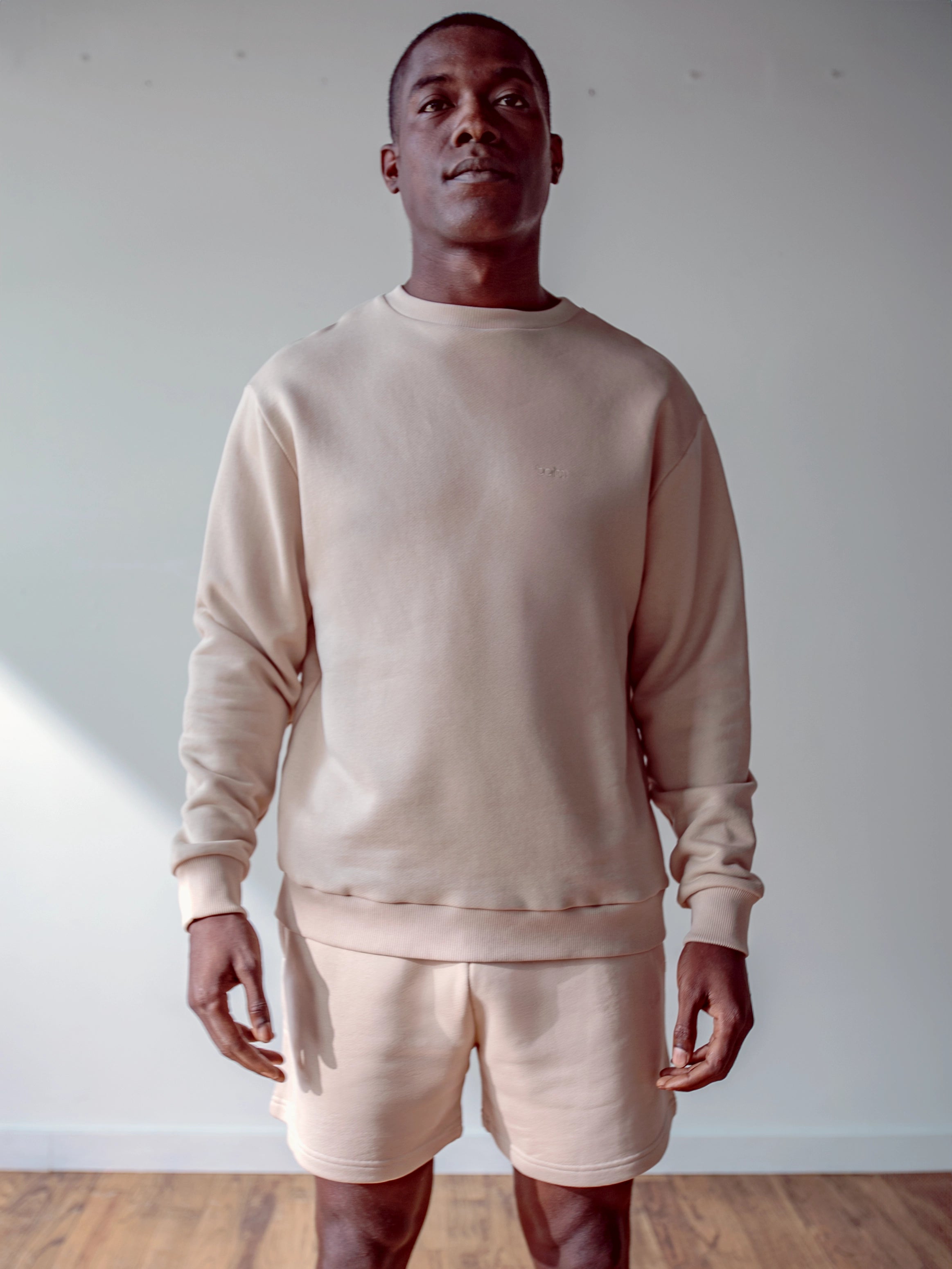 Close-up of a single green leaf against a white background.
