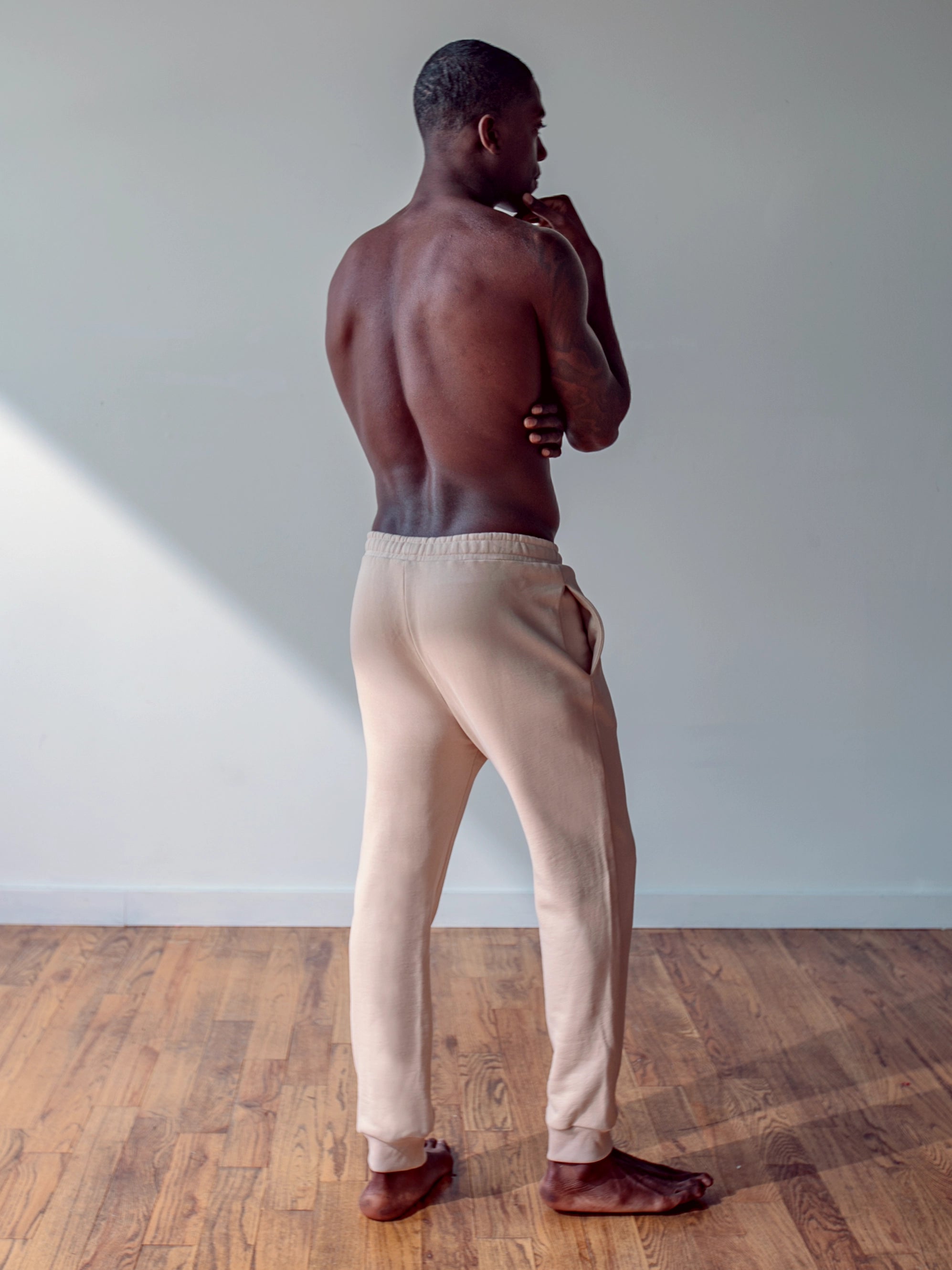 Close-up of a single green leaf against a white background.