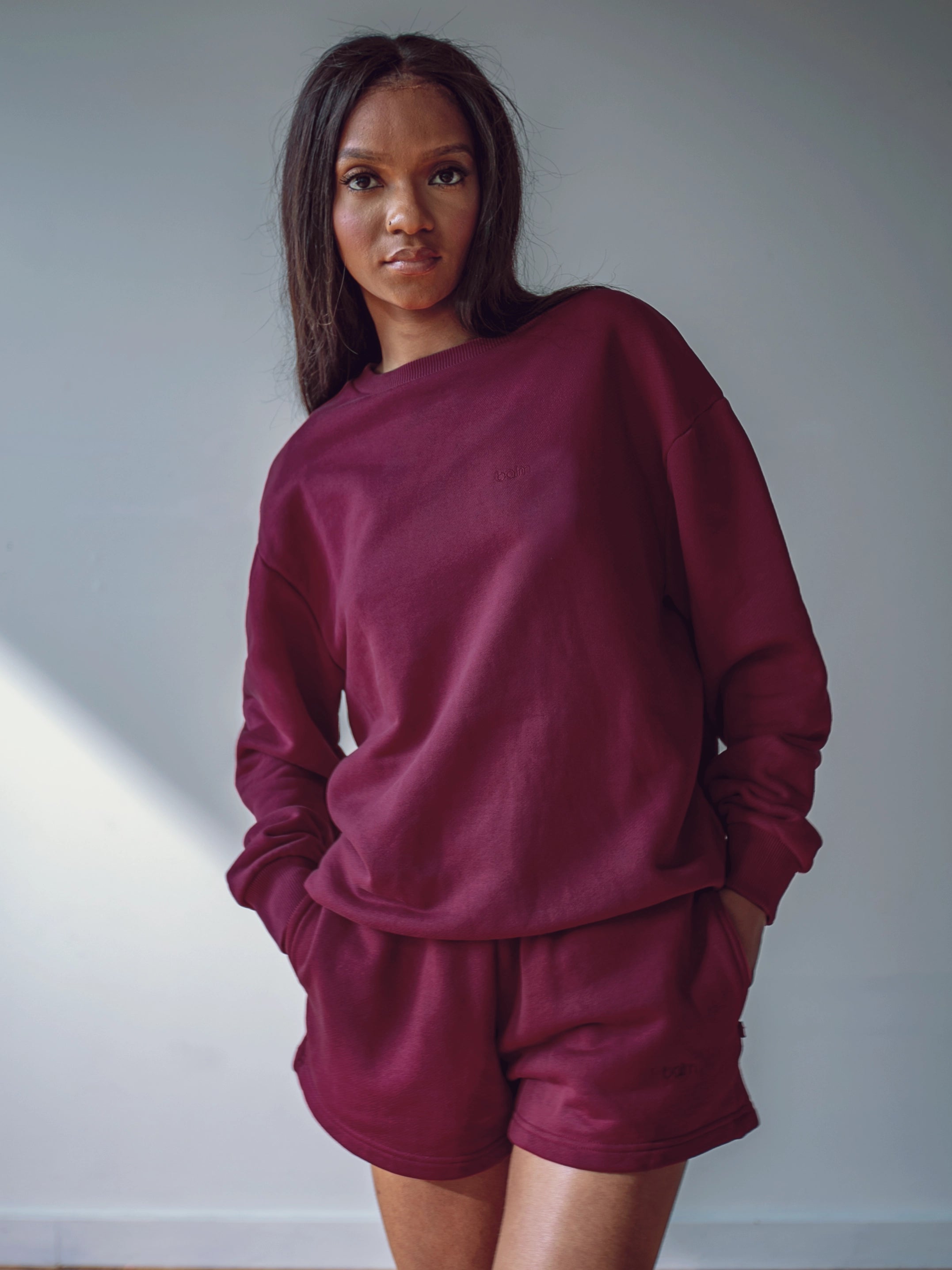 Close-up of a single green leaf against a white background.