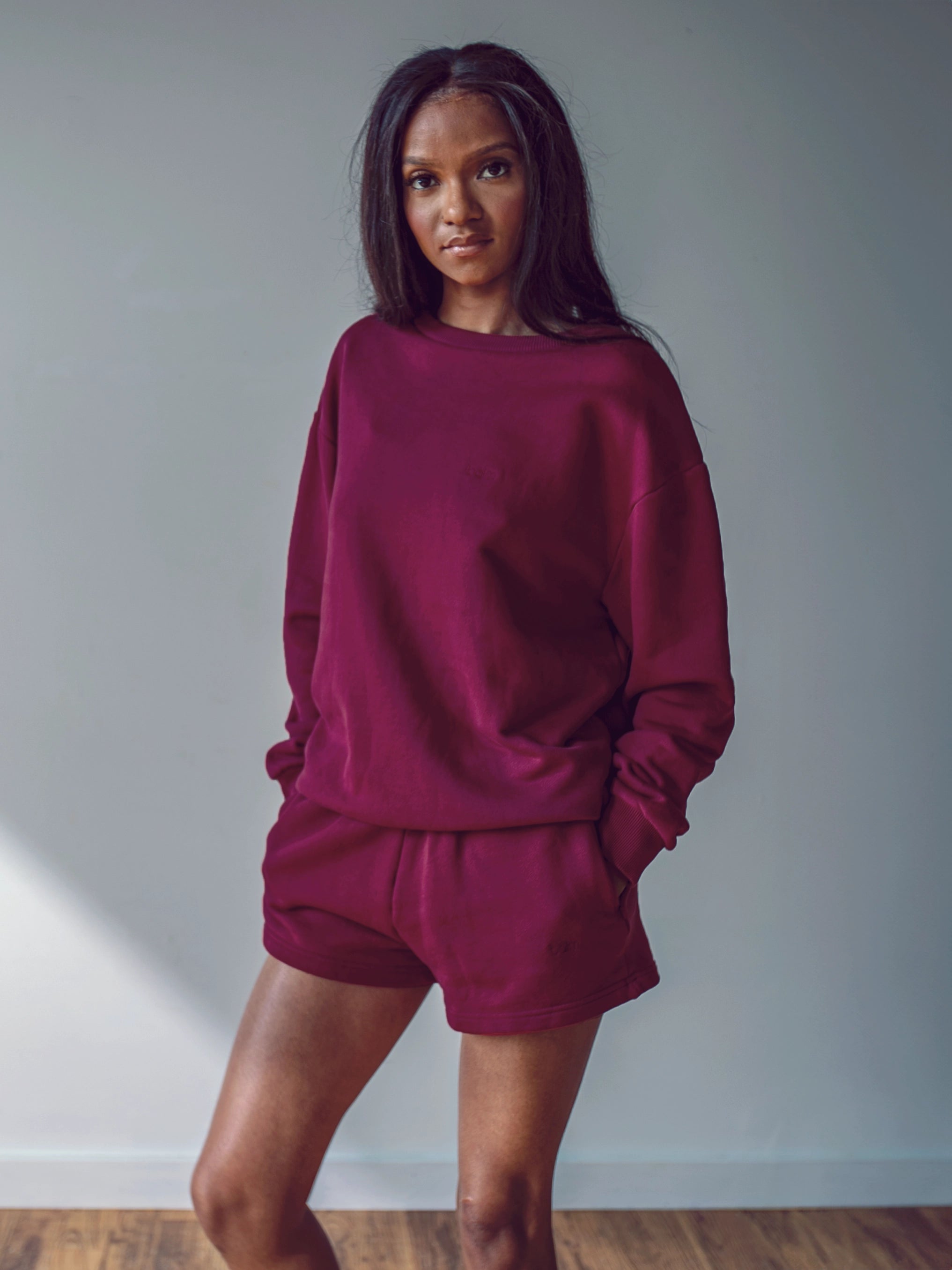 Close-up of a single green leaf against a white background.