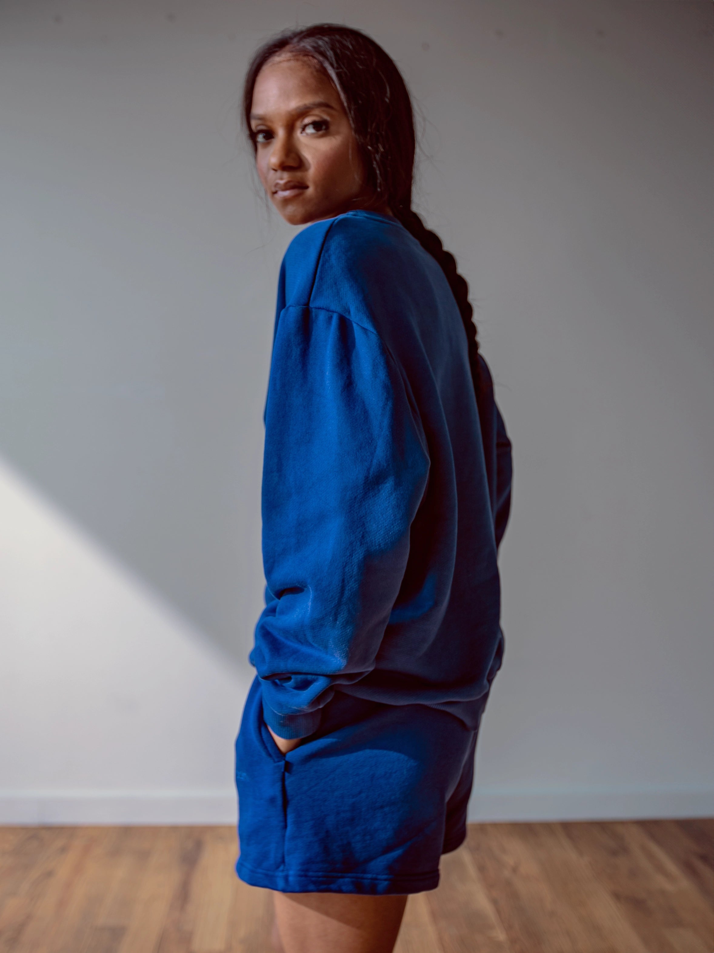 Close-up of a single green leaf against a white background.