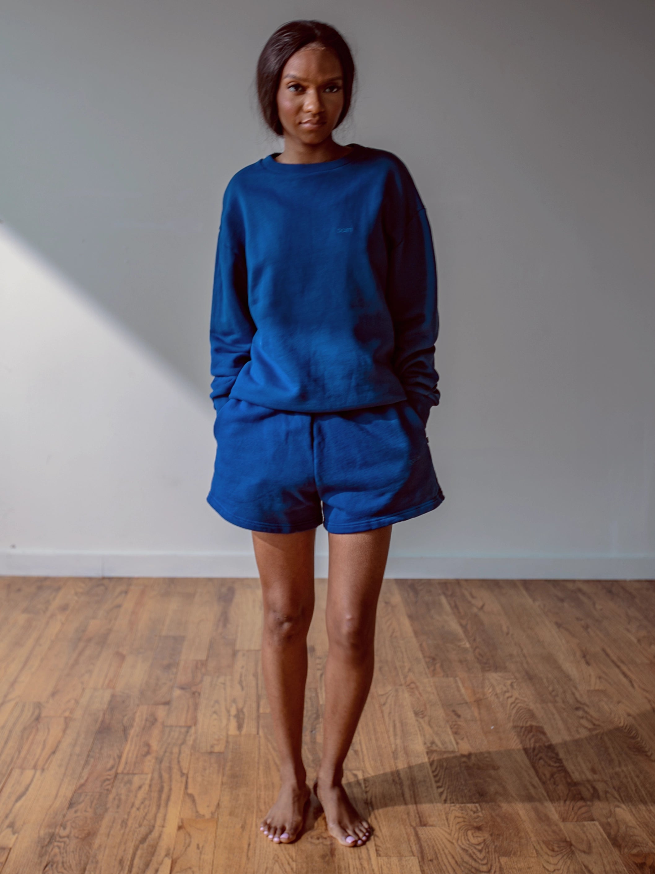 Close-up of a single green leaf against a white background.