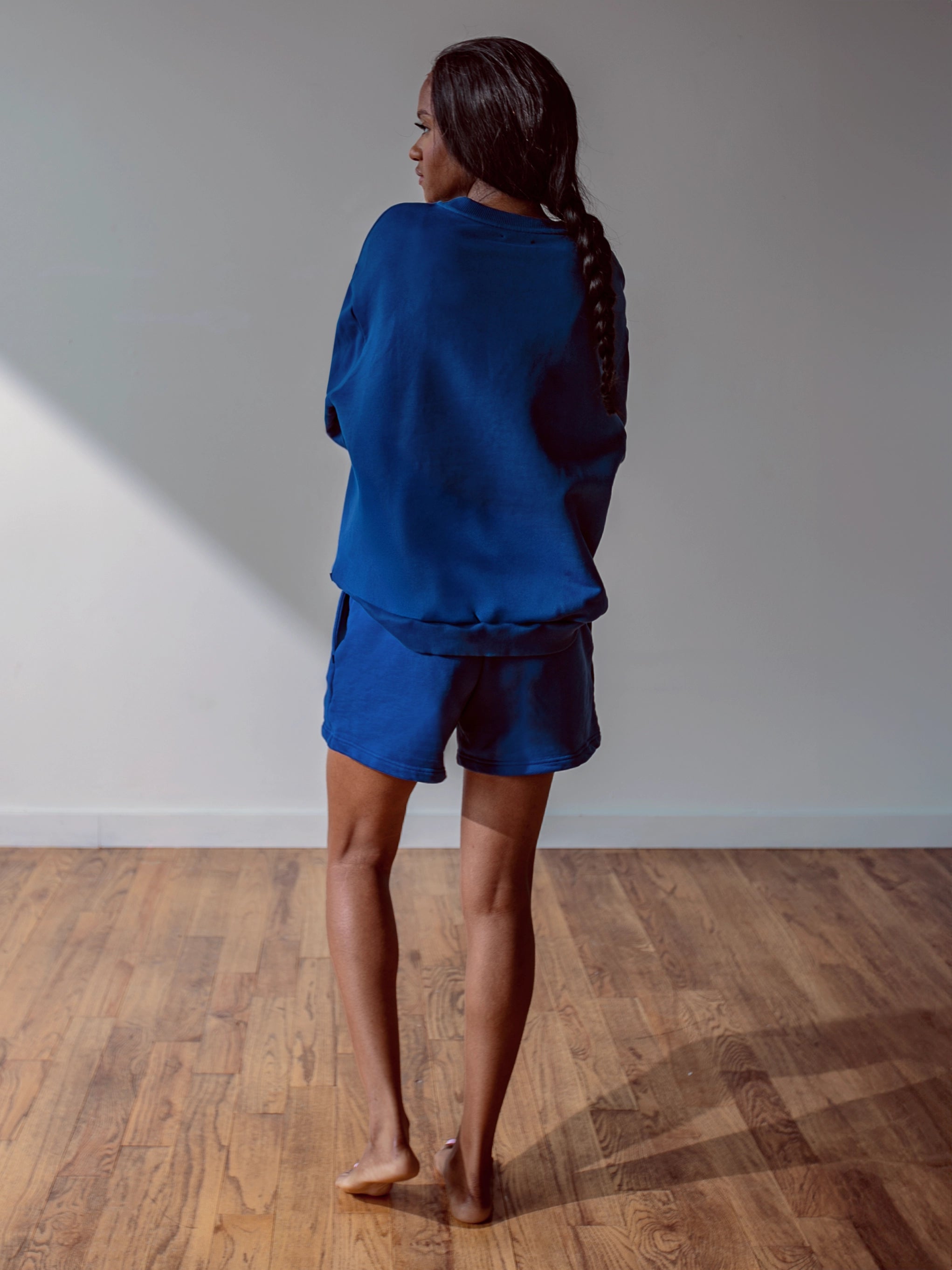 Close-up of a single green leaf against a white background.