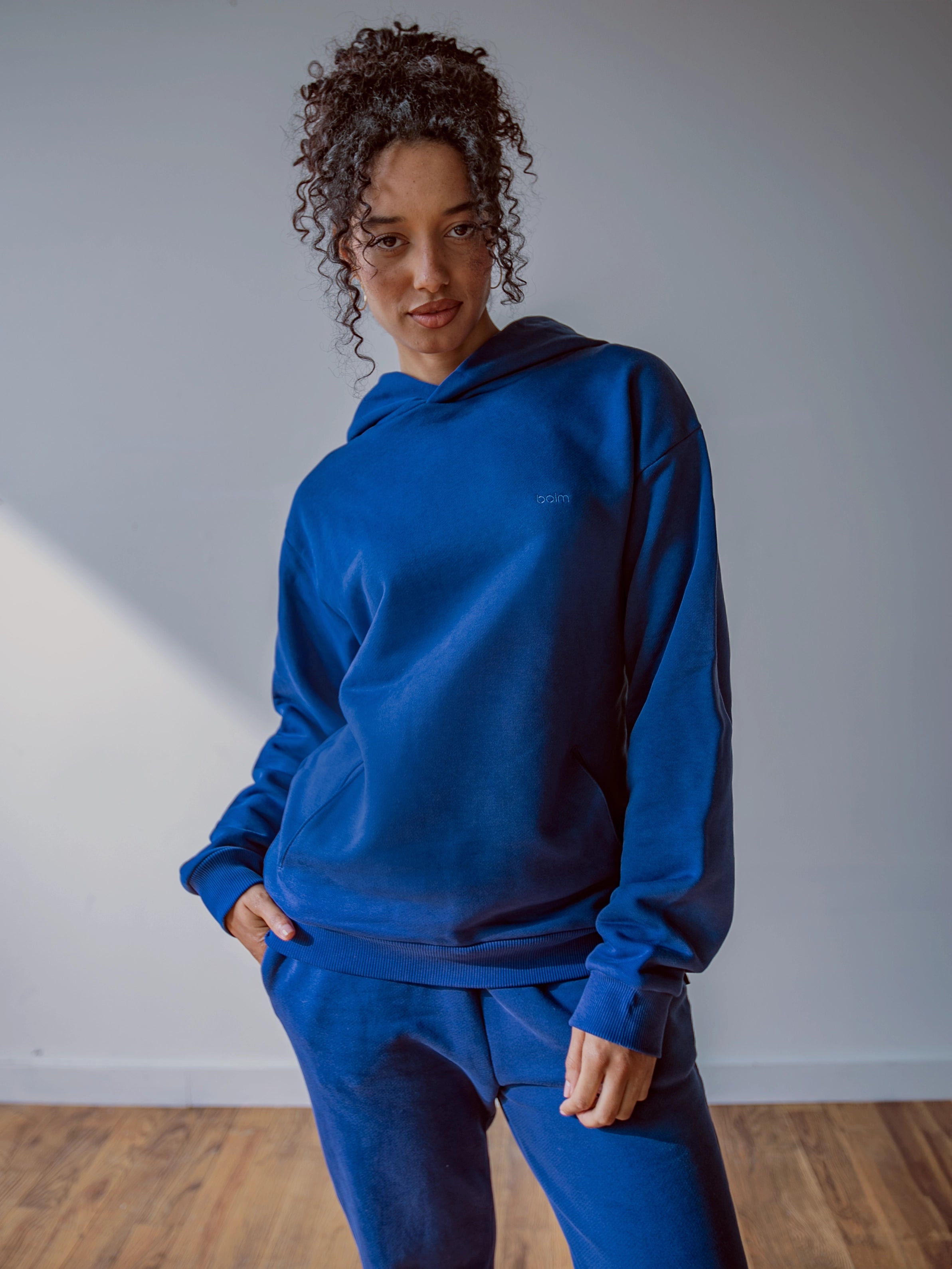 Close-up of a single green leaf against a white background.