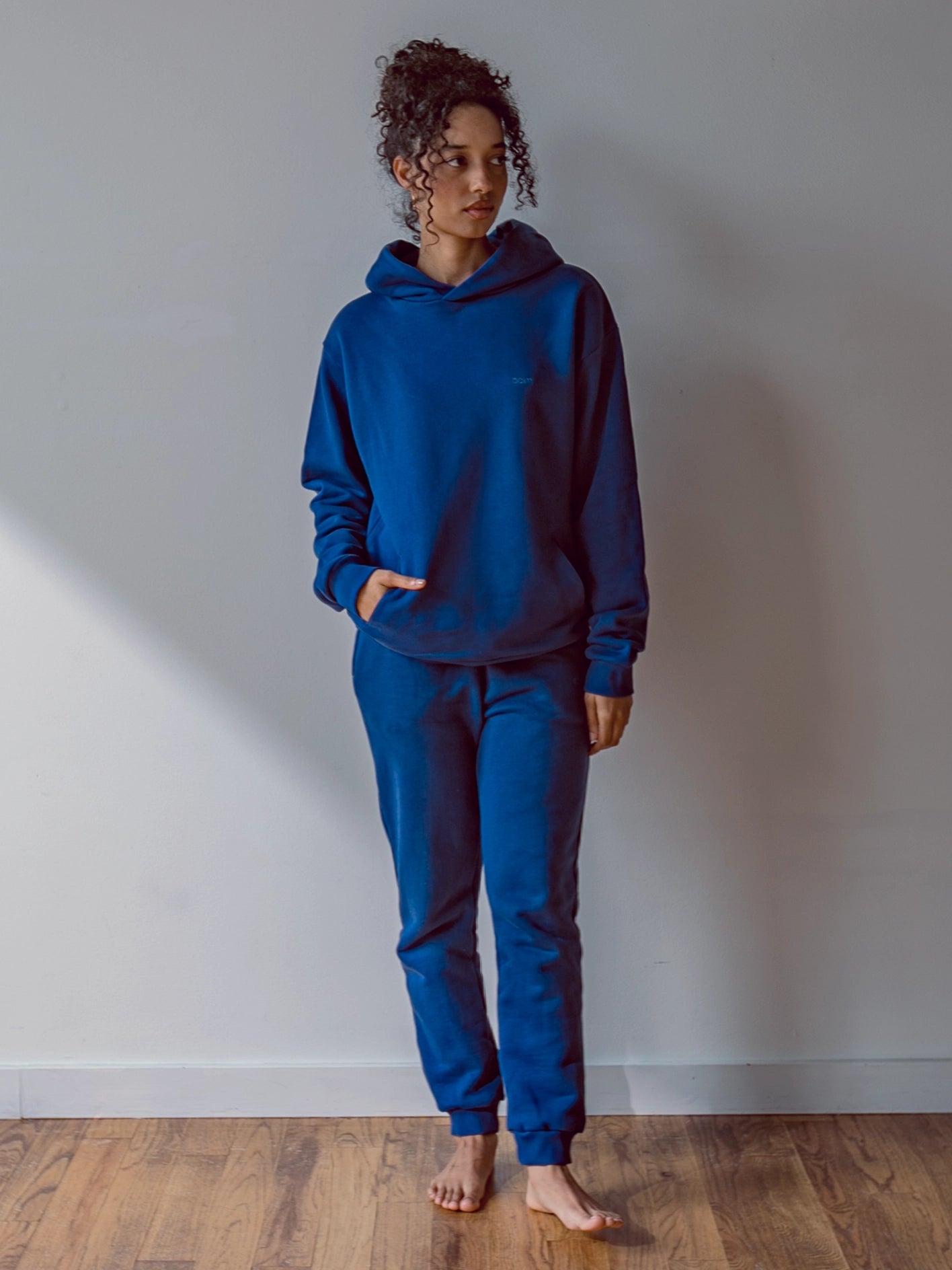 Close-up of a single green leaf against a white background.