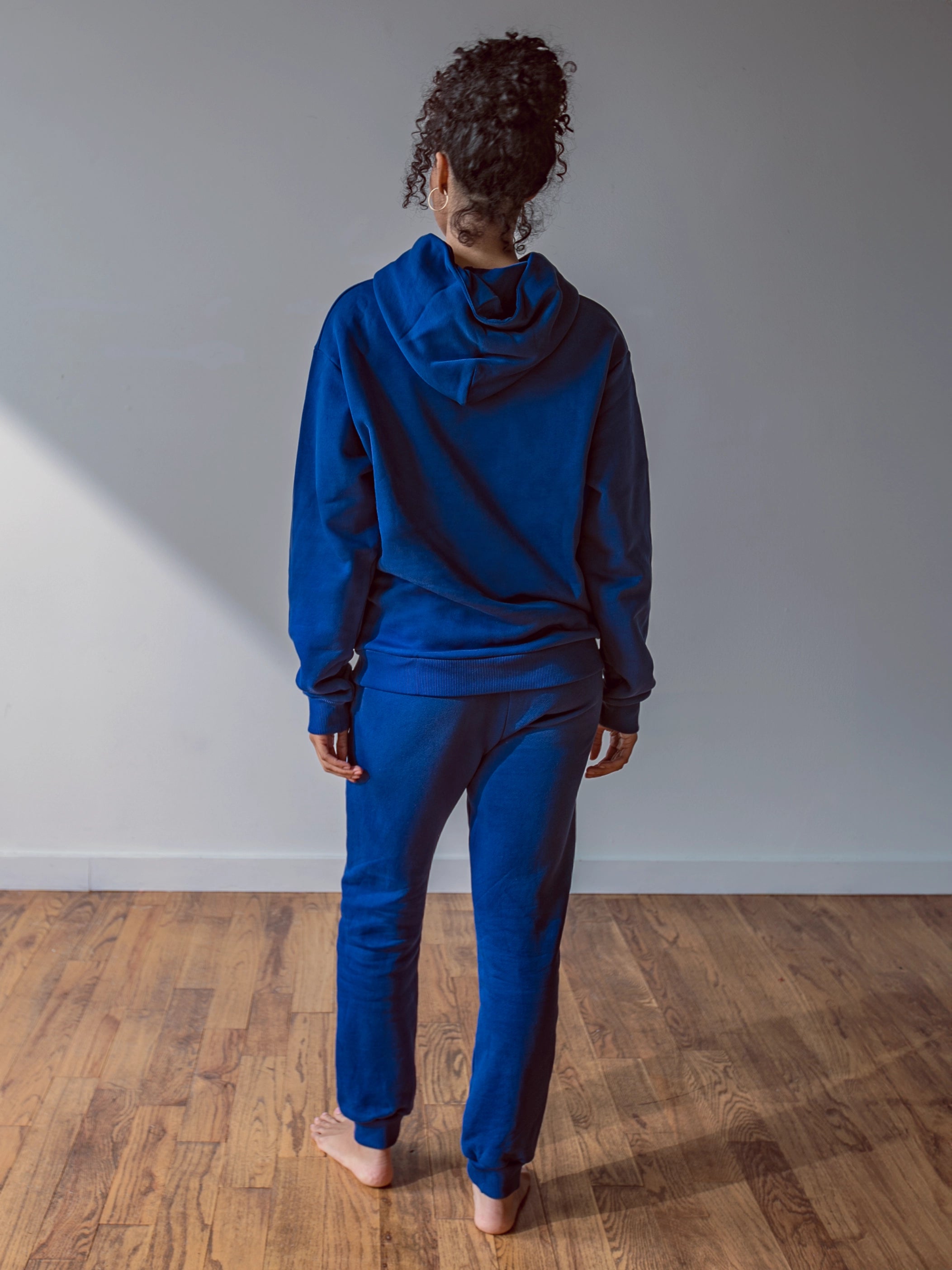 Close-up of a single green leaf against a white background.