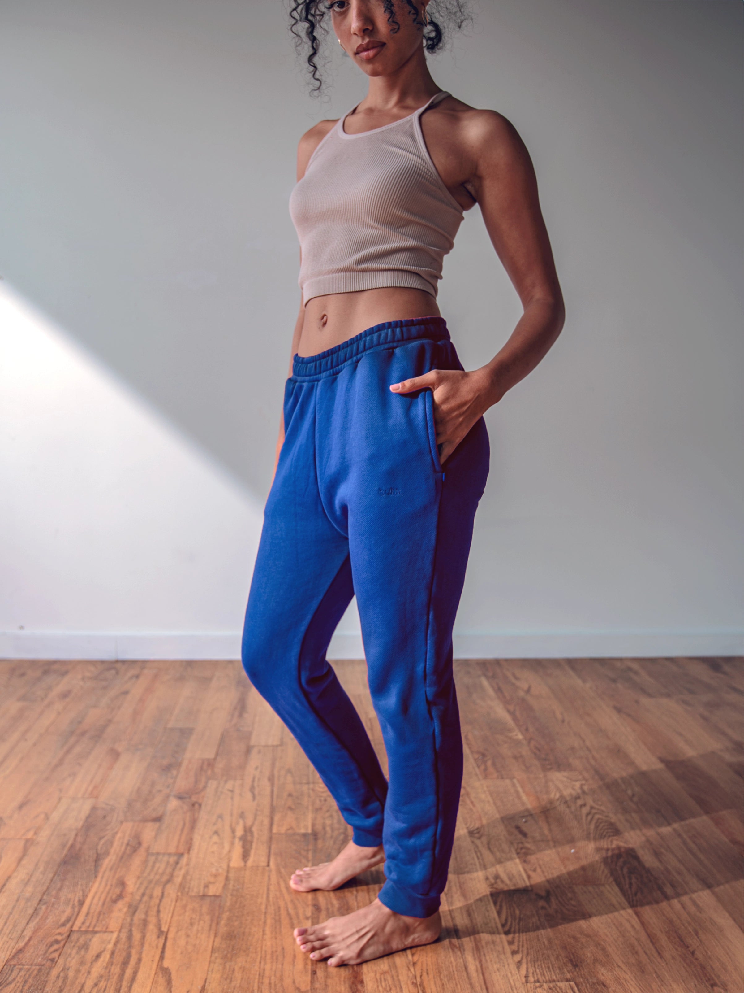 Close-up of a single green leaf against a white background.