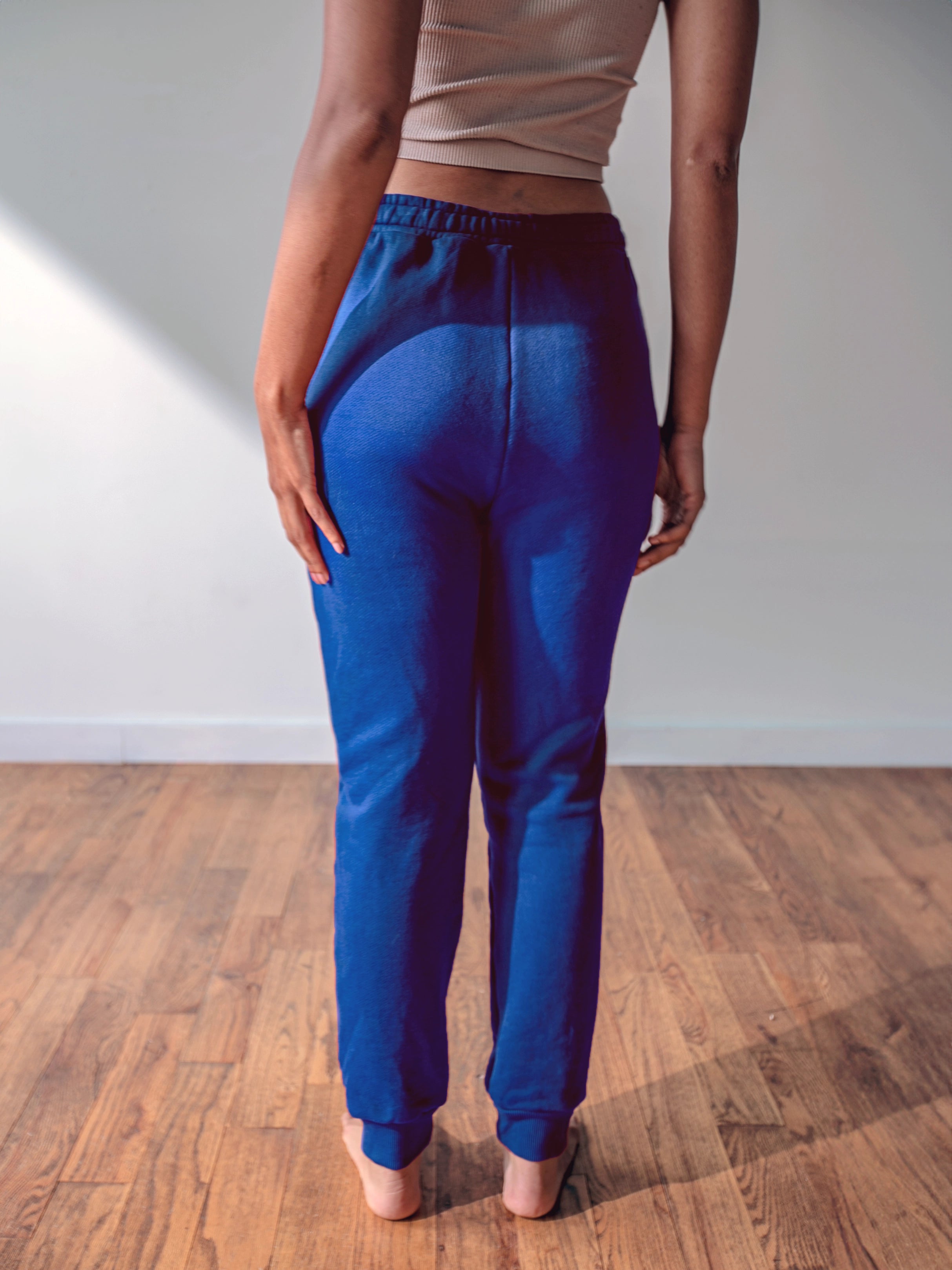 Close-up of a single green leaf against a white background.