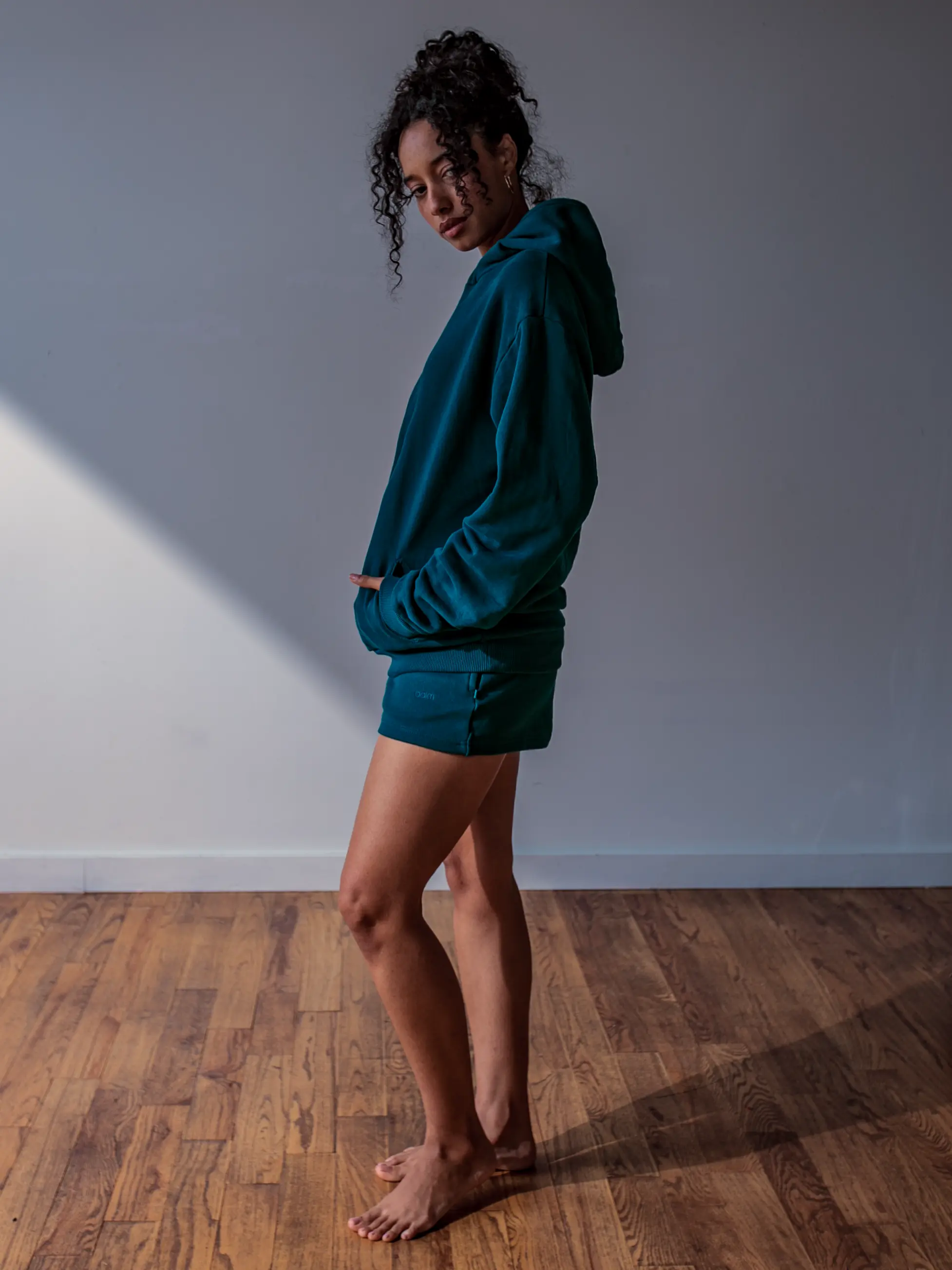 Close-up of a single green leaf against a white background.