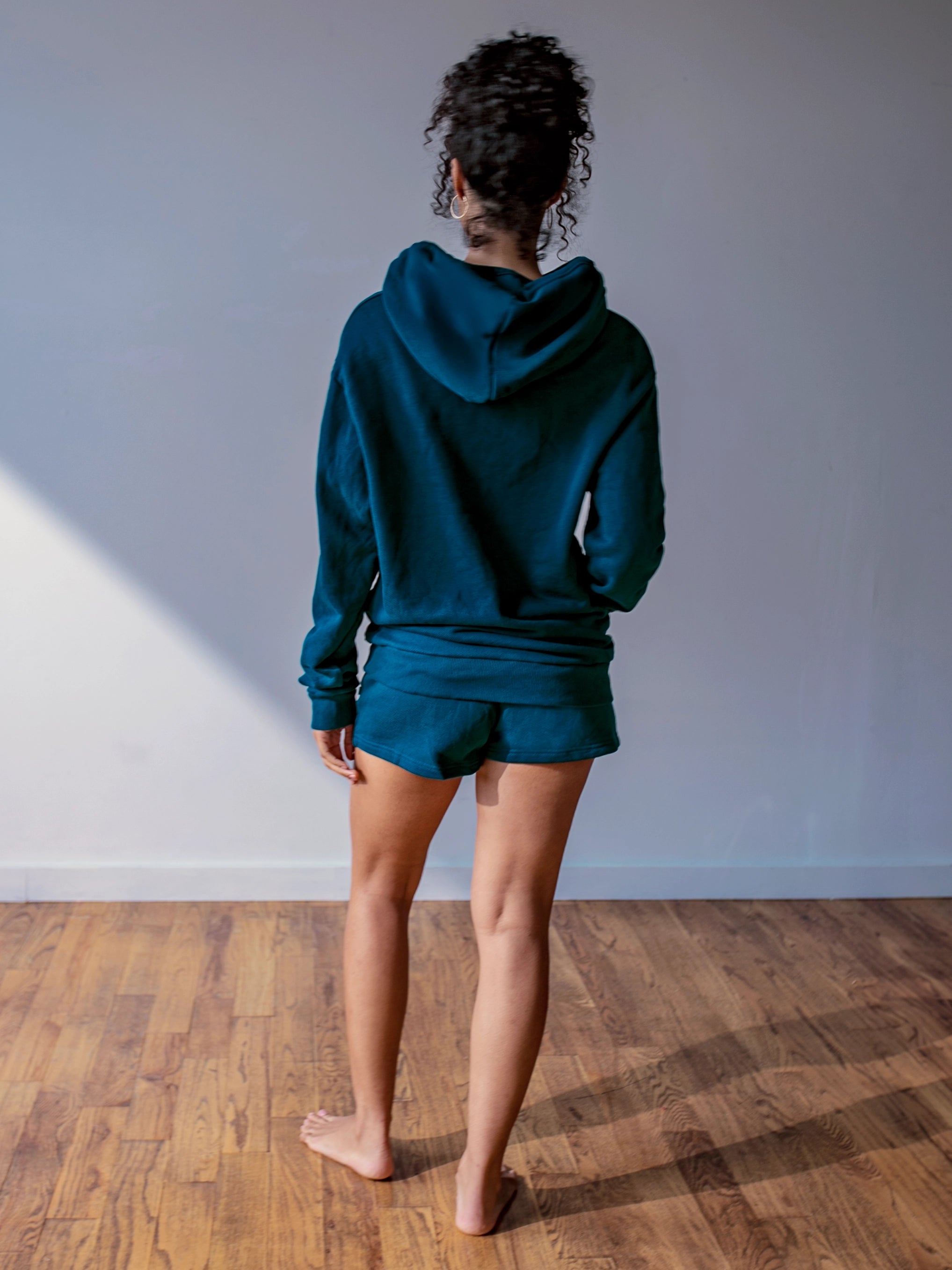 Close-up of a single green leaf against a white background.