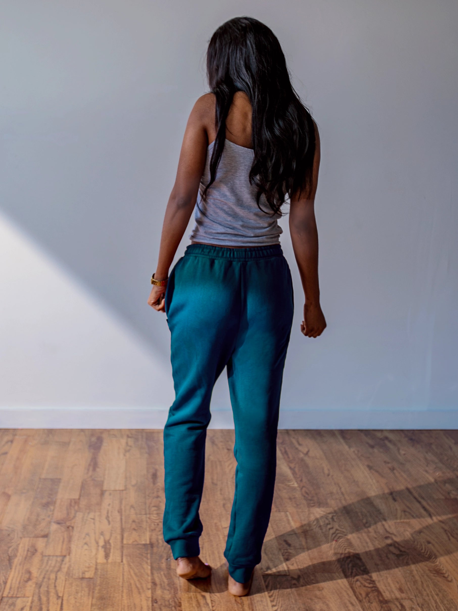 Close-up of a single green leaf against a white background.