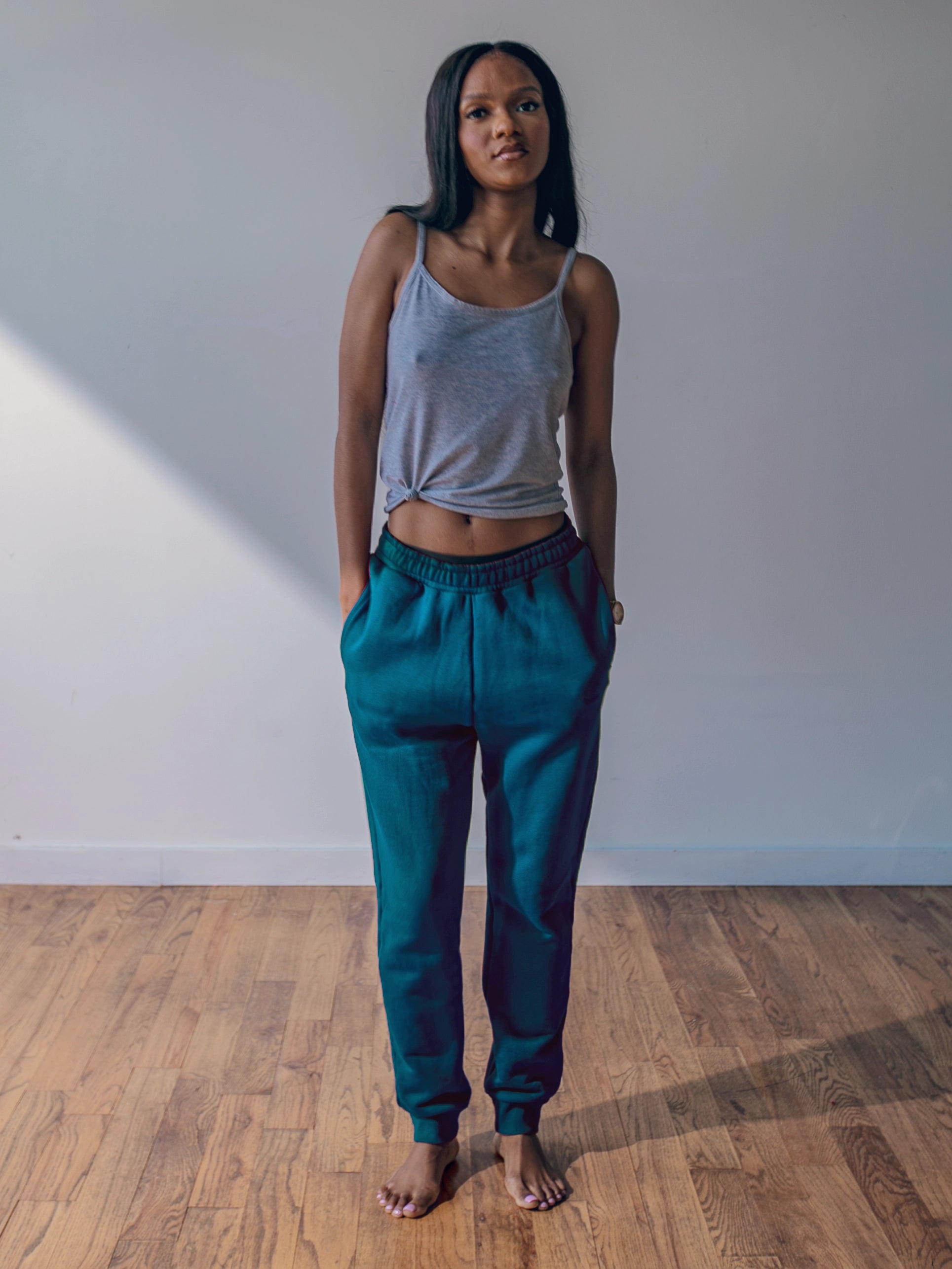 Close-up of a single green leaf against a white background.