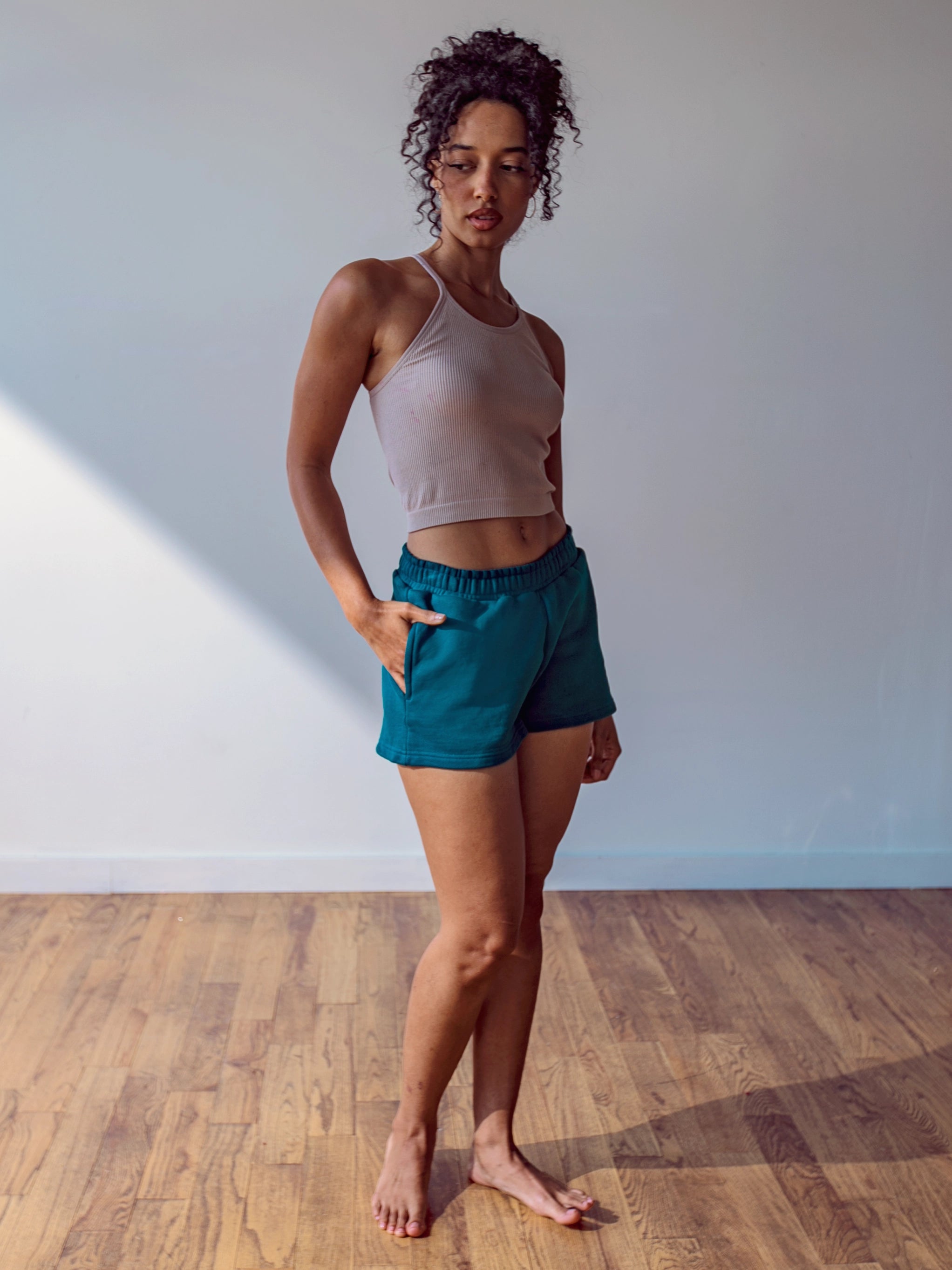 Close-up of a single green leaf against a white background.