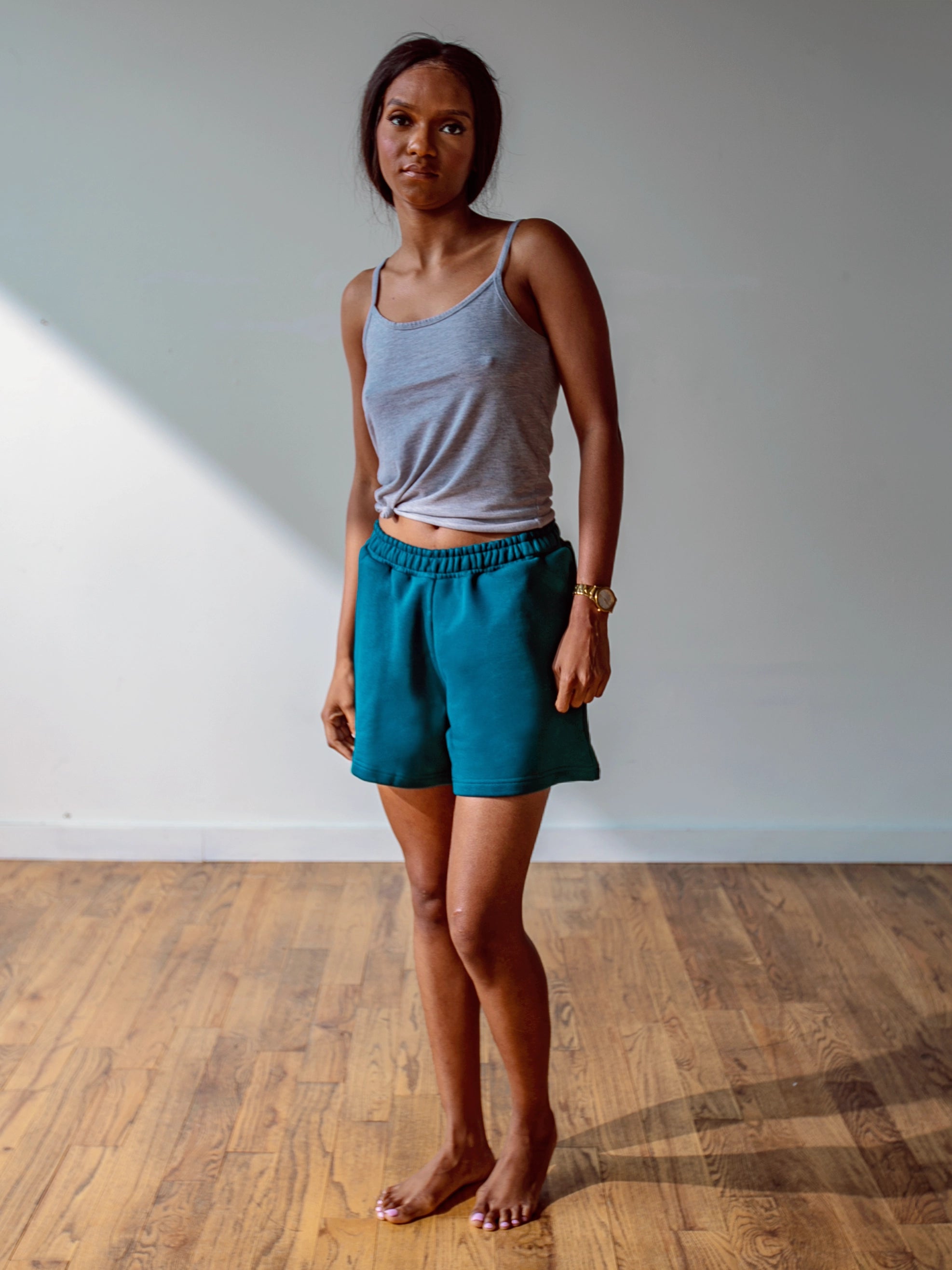 Close-up of a single green leaf against a white background.
