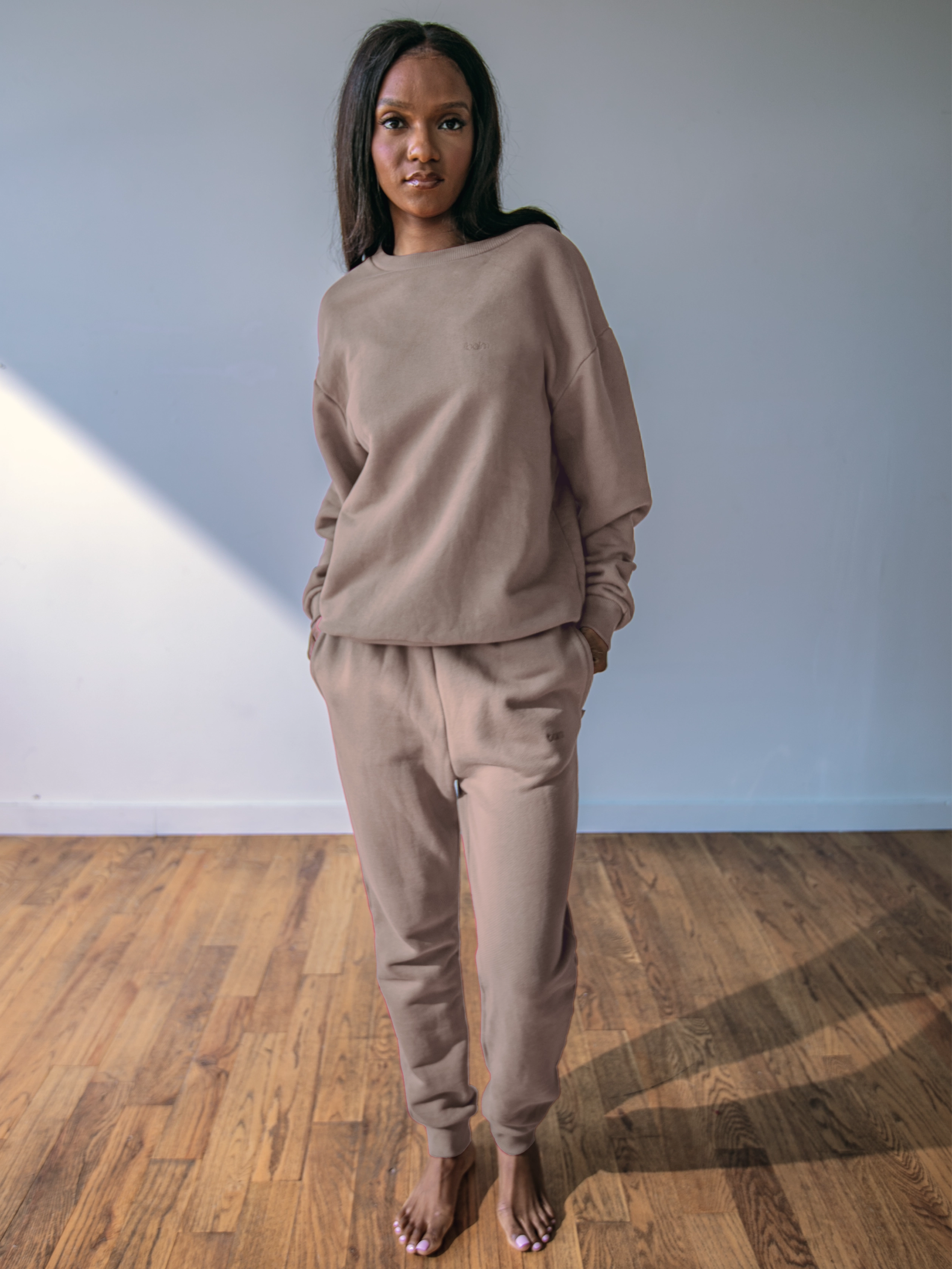 Close-up of a single green leaf against a white background.