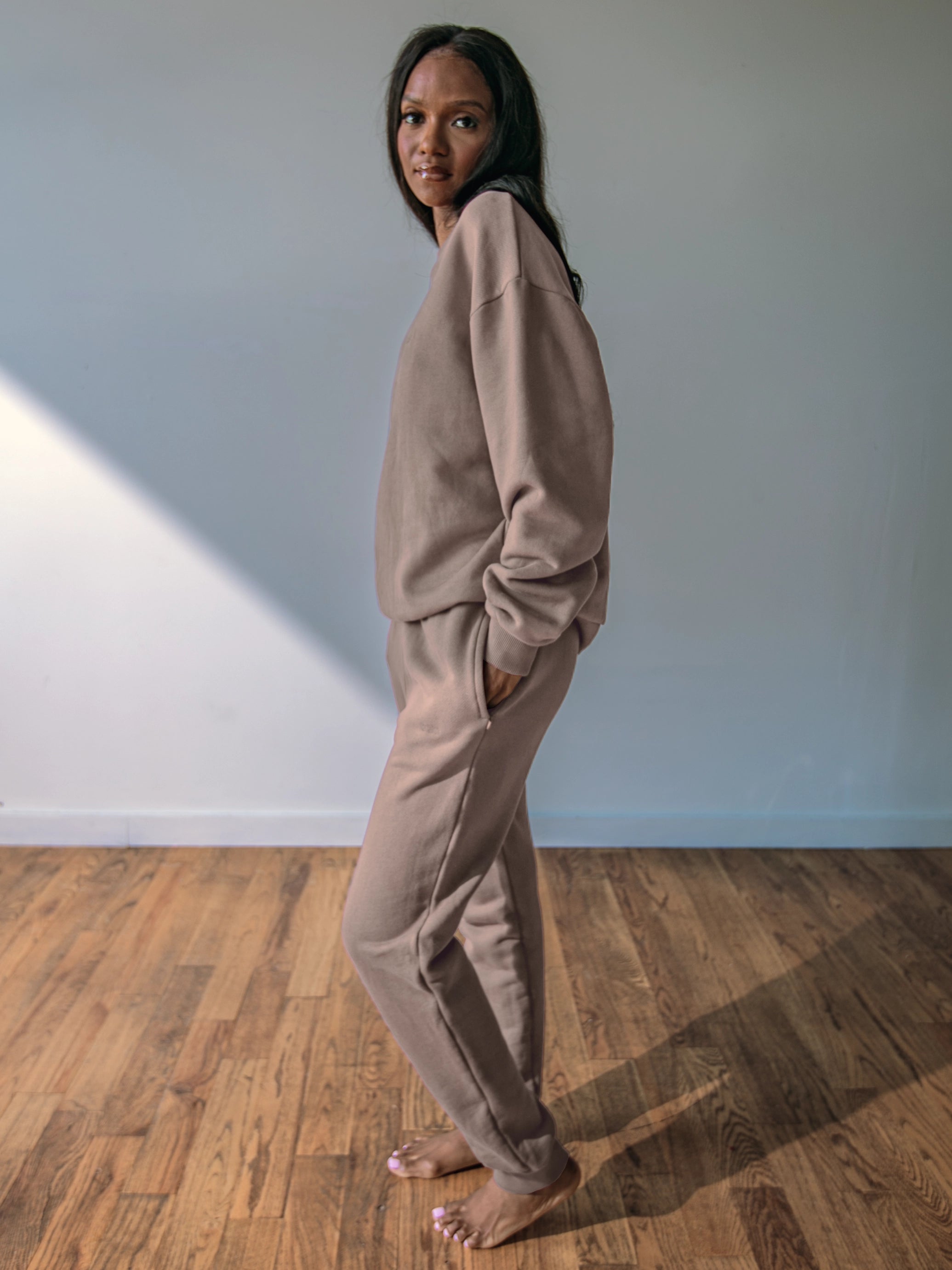 Close-up of a single green leaf against a white background.