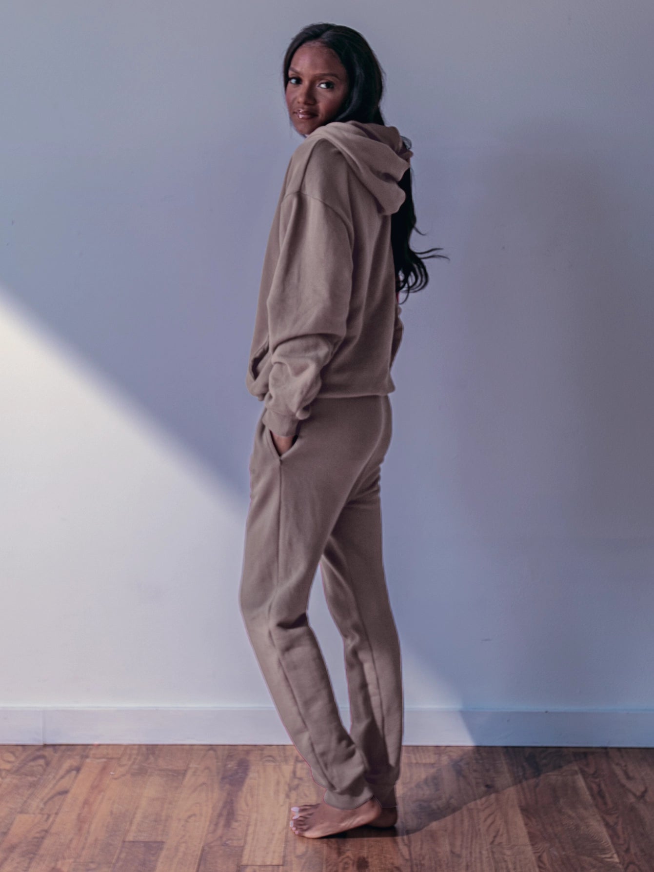 Close-up of a single green leaf against a white background.