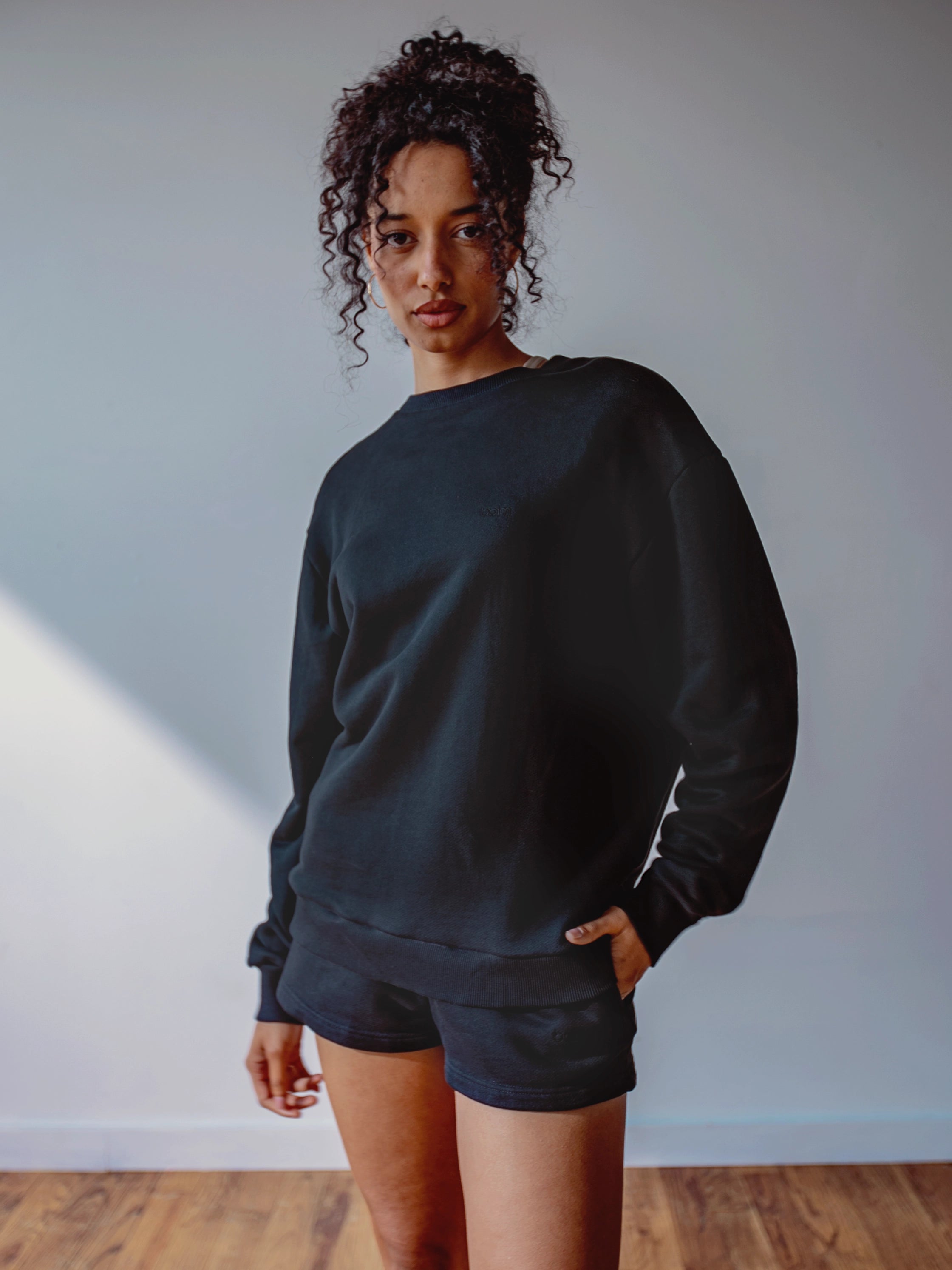 Close-up of a single green leaf against a white background.