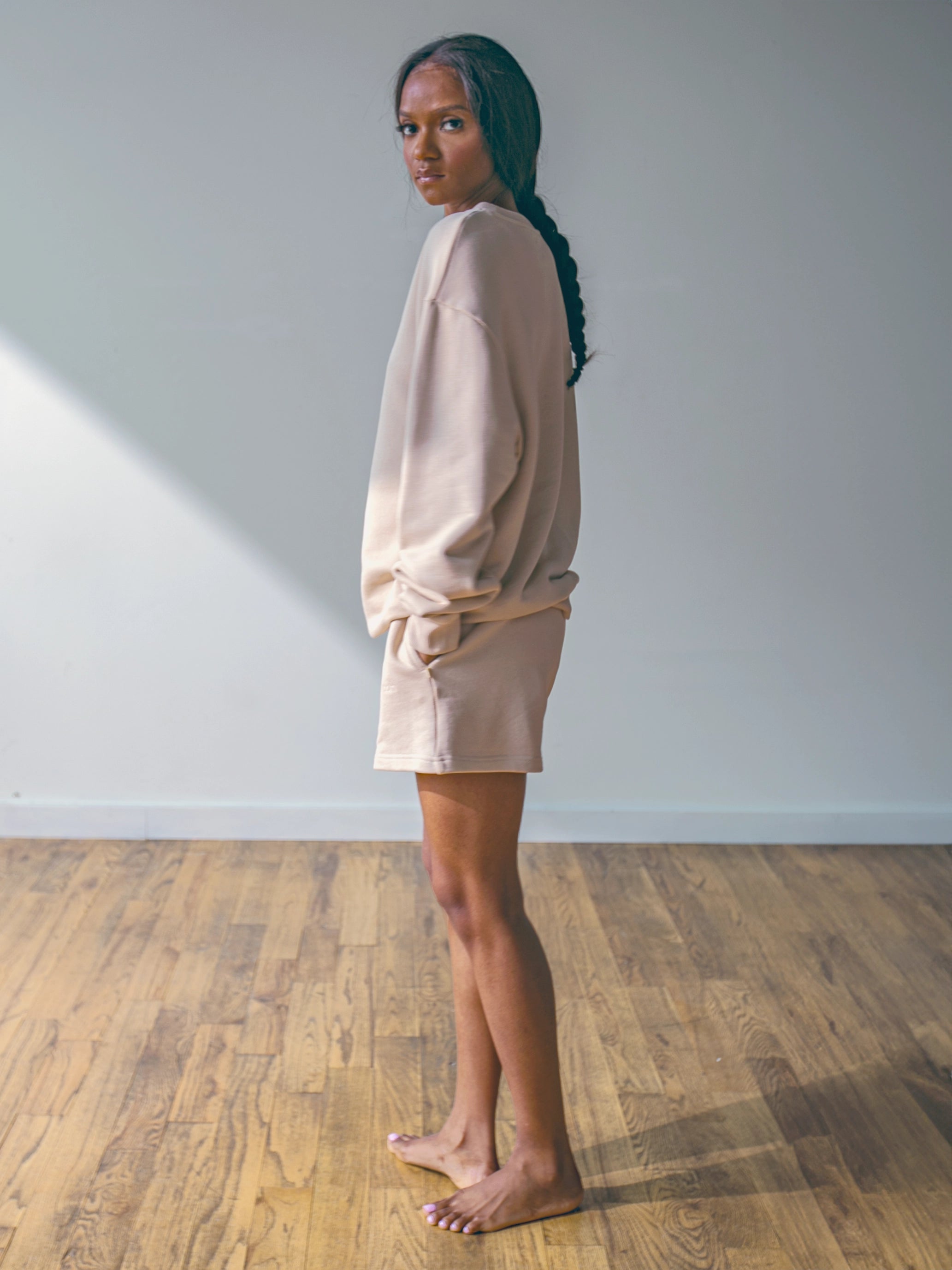 Close-up of a single green leaf against a white background.
