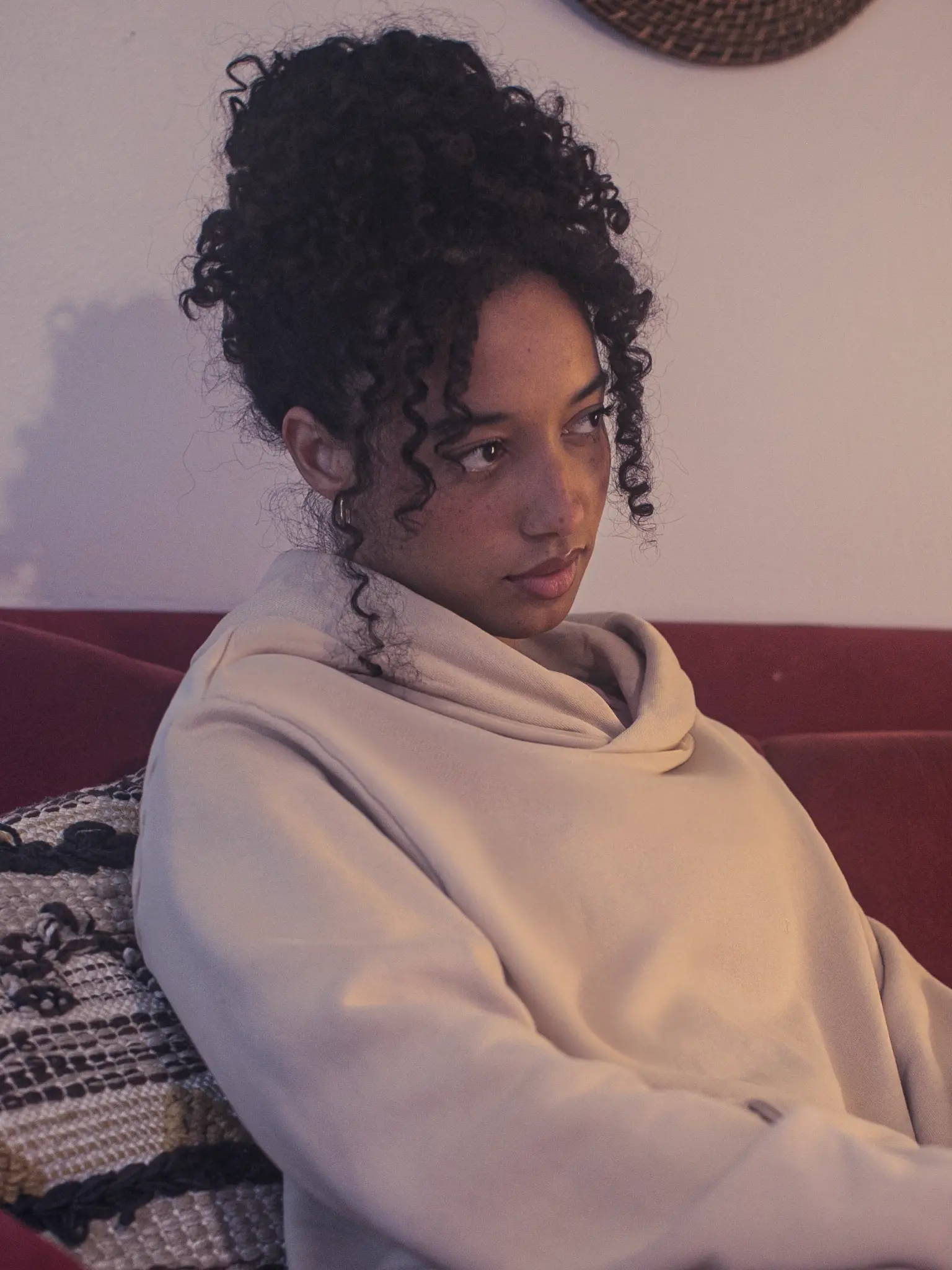 Cream-colored hoodie on a wood-textured background.